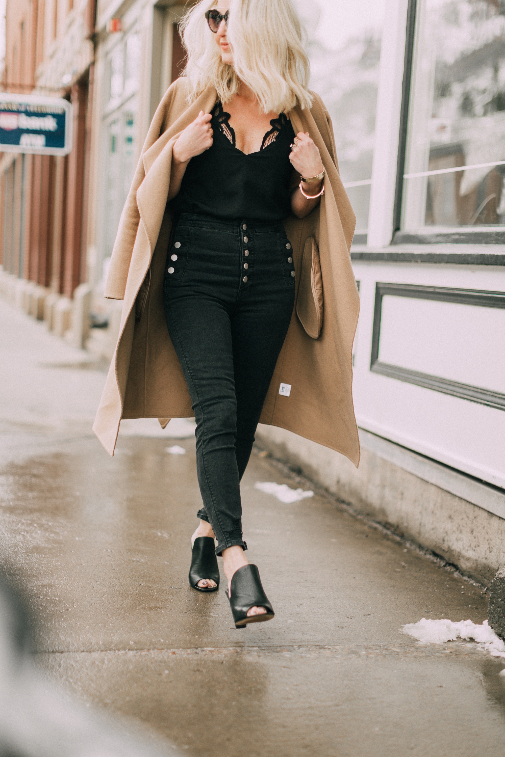 Shoe Trend: Mules, featuring the black Gerrty mules from Vince Camuto with black jeans by J. Brand, black cami, and camel coat worn by fashion blogger over 40 Erin Busbee of BusbeeStyle.com in Telluride, Colorado