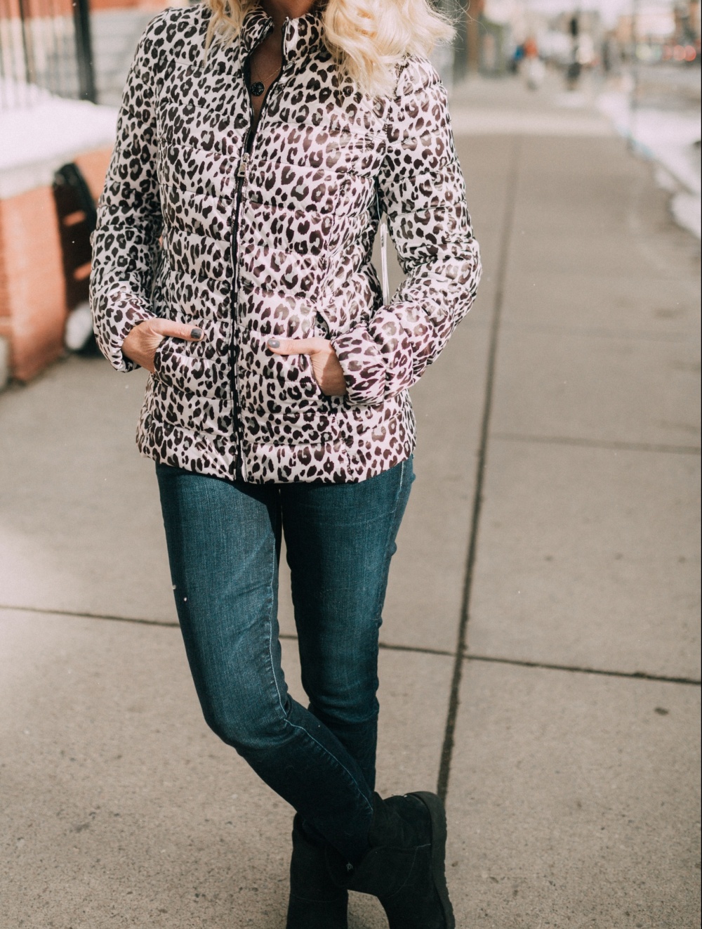 Fashion blogger Erin Busbee of BusbeeStyle.com wearing a leopard puffer jacket by Aqua from Bloomingdale's in Telluride, CO