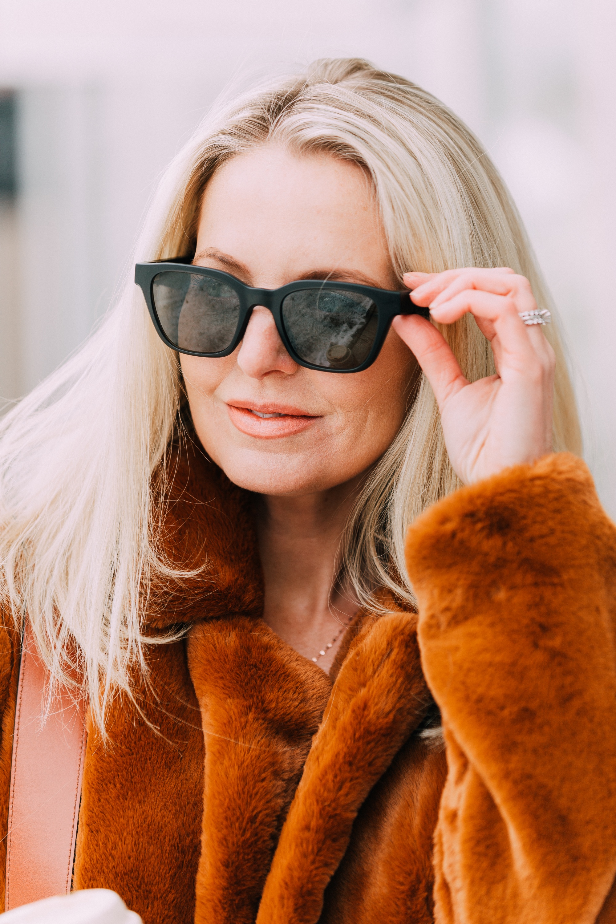 Bose Frames review by lifestyle blogger Erin Busbee, BusbeeStyle.com, wearing the Alto frames in black with a brown faux fur jacket by BlankNYC and carrying a sepia Chloe Tess Bag