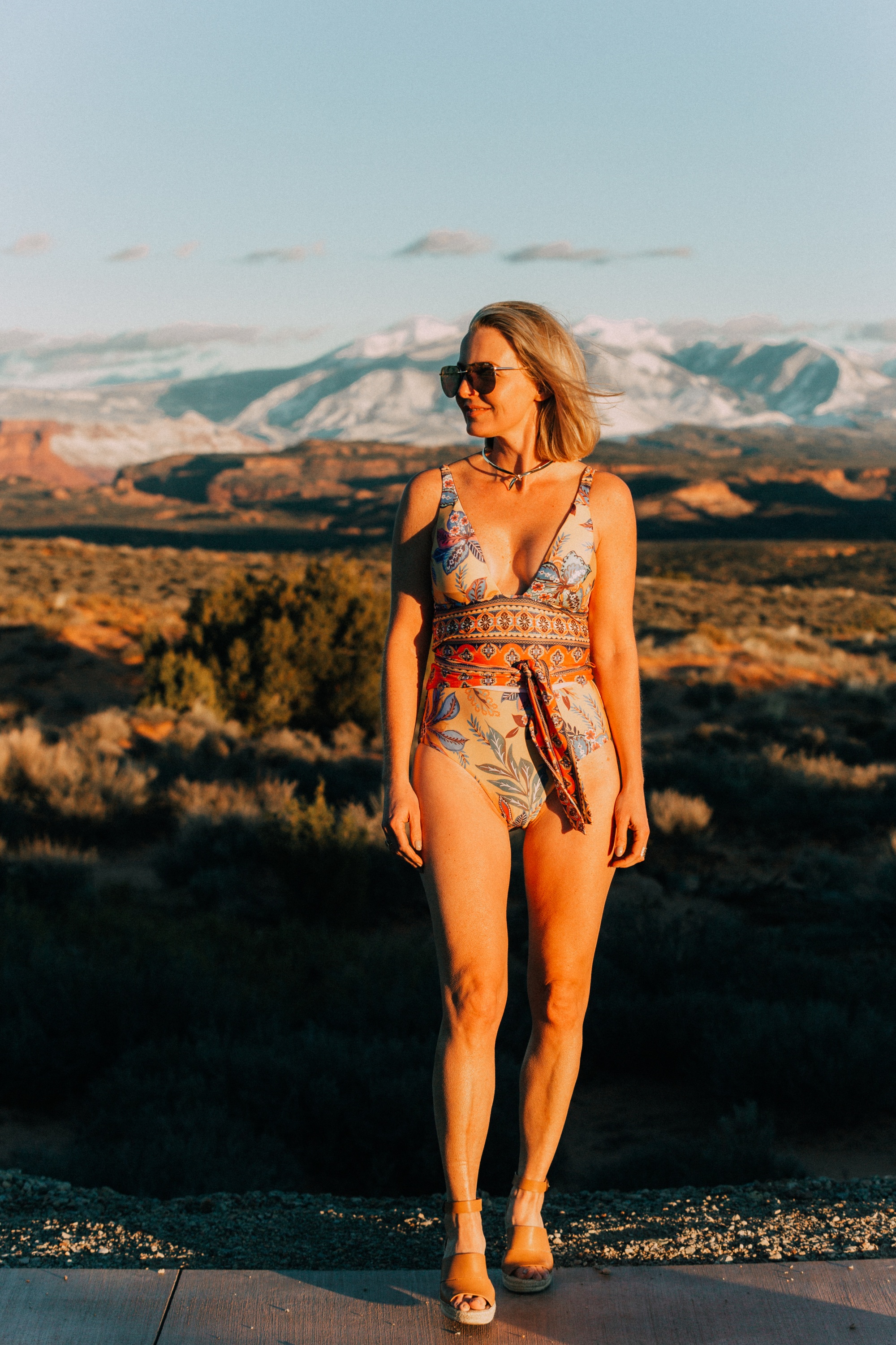 Full Coverage one piece paisley swimsuit by becca for women over 40 years old with Eddie Bargo choker necklace, and Treasure & Bond espadrille sandals in Moab, Utah