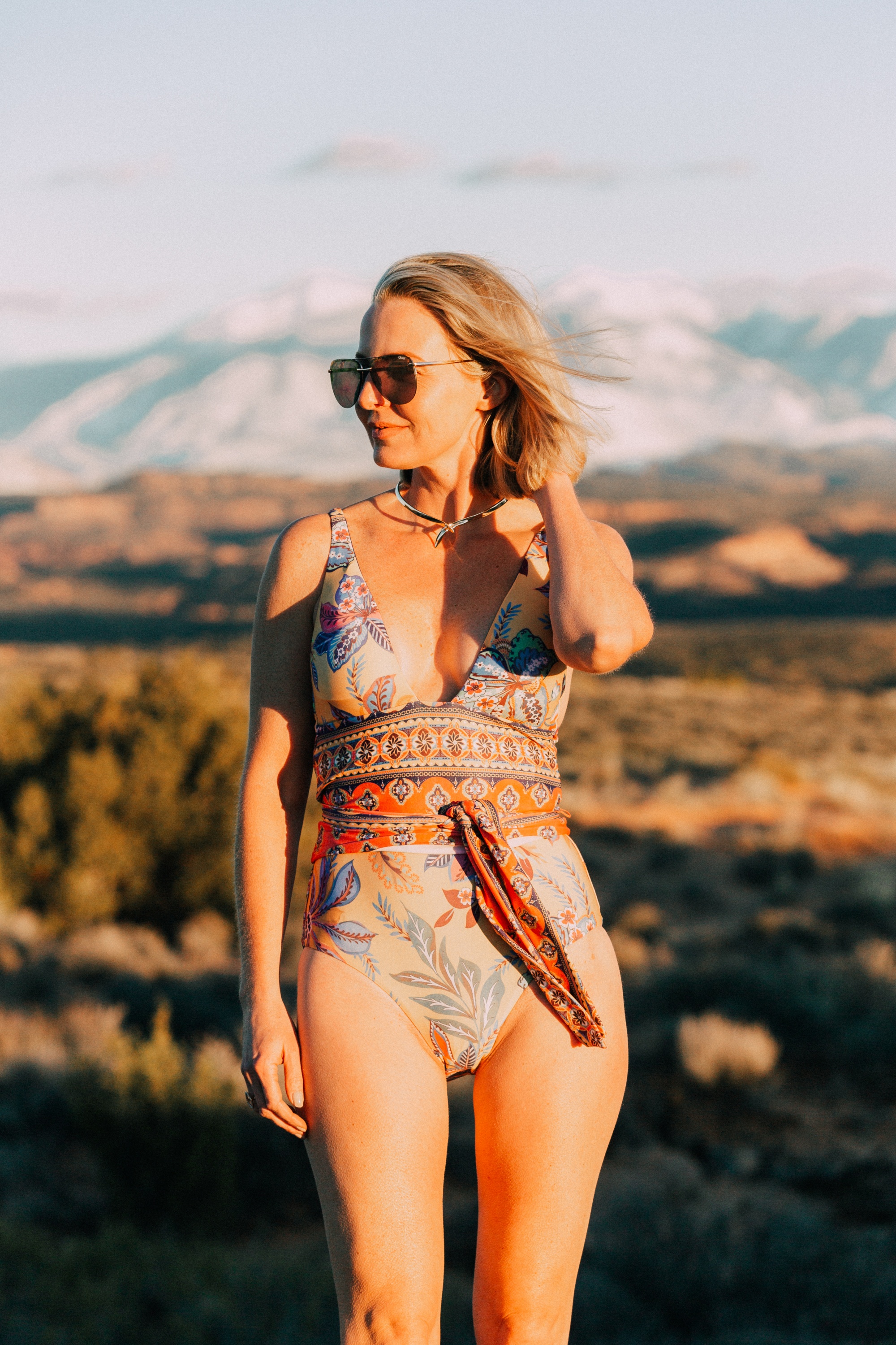 Full Coverage Swimsuits, Fashion blogger Erin Busbee of BusbeeStyle.com wearing a paisley print one piece swimsuit by Becca in Moab, Utah