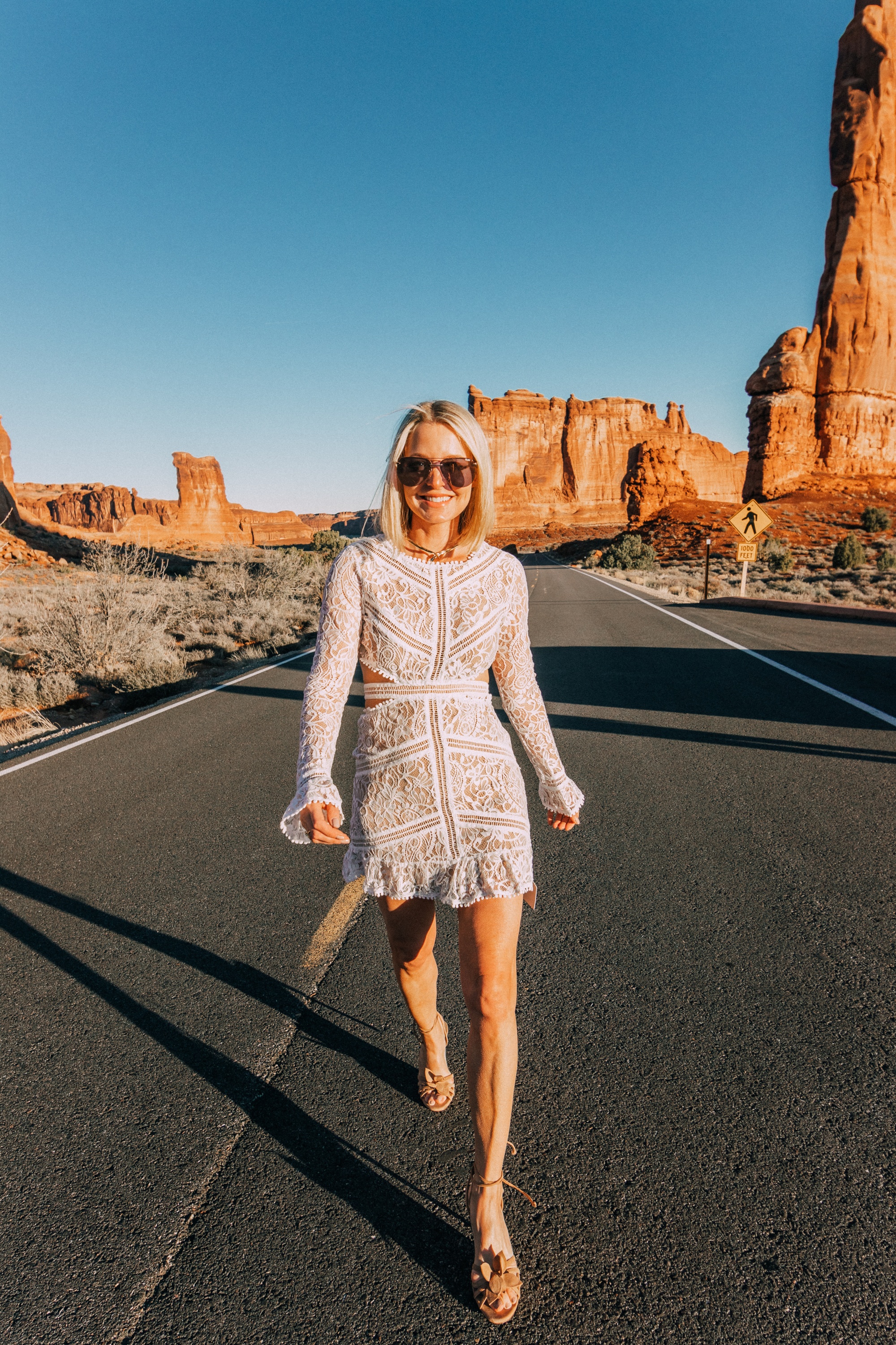 Unique White Dresses, fashion blogger over 40 Erin Busbee of BusbeeStyle.com wearing a white open back lace white mini dress by For Love & Lemons in Moab, Utah,fashion trends, spring fashion trends, fashion trends 2022