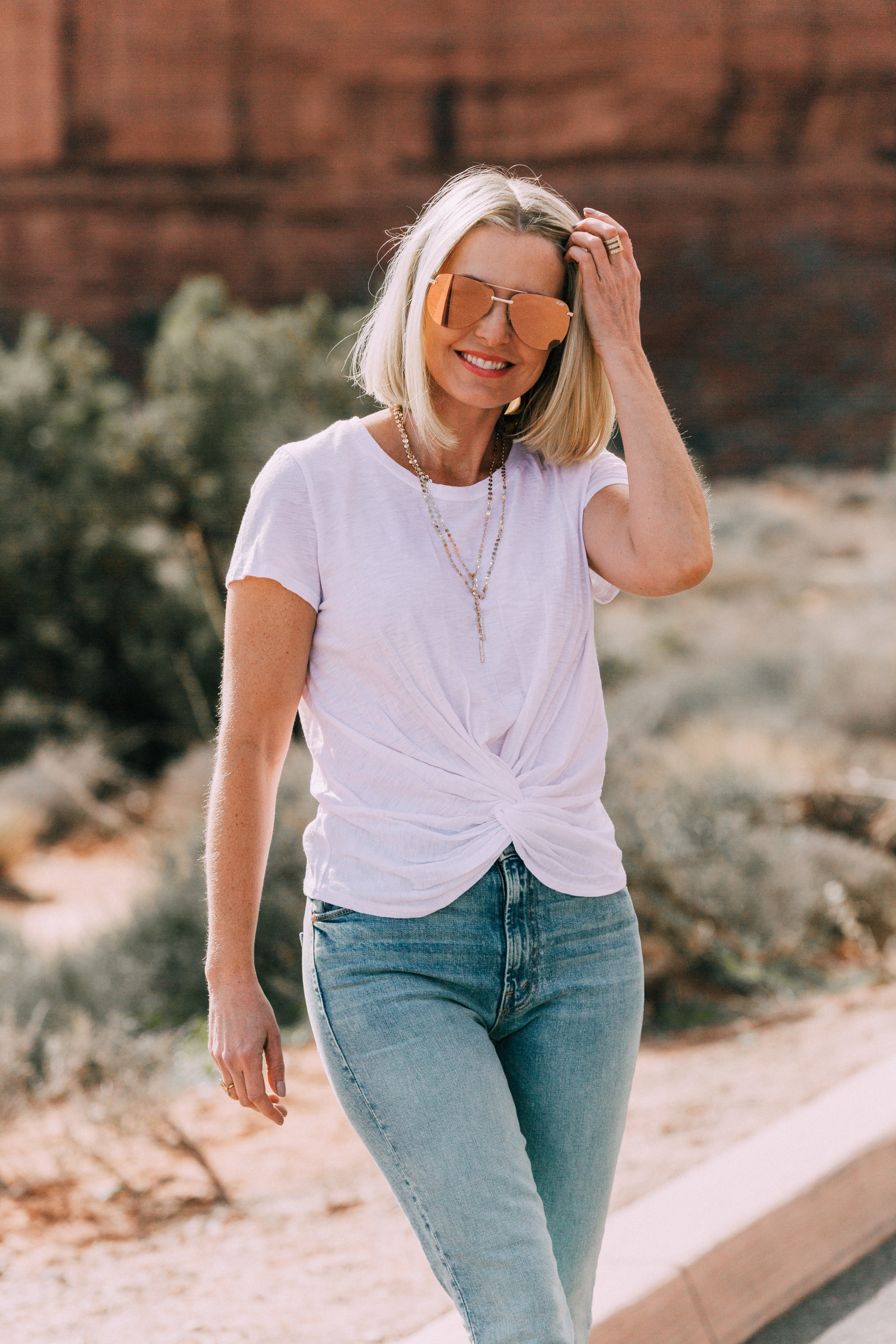 fashion blogger showing the perfect white t shirt from Aqua wearing with mother the rascal blue jeans