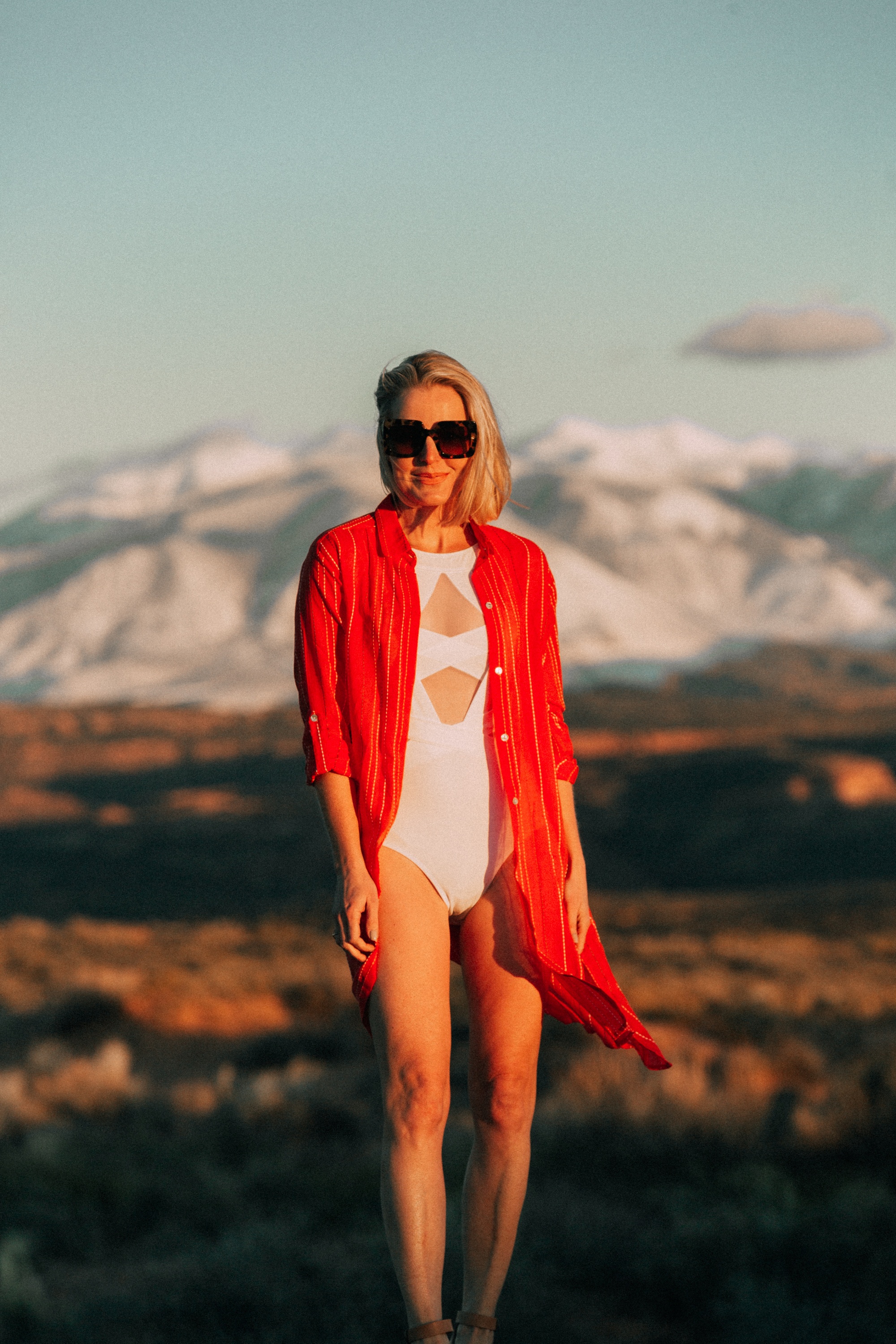 Full Coverage Swimsuits, fashion blogger Erin Busbee of BusbeeStyle.com wearing an orange Vix cover up with a white mesh OYE one piece swimsuit in Moab, Utah