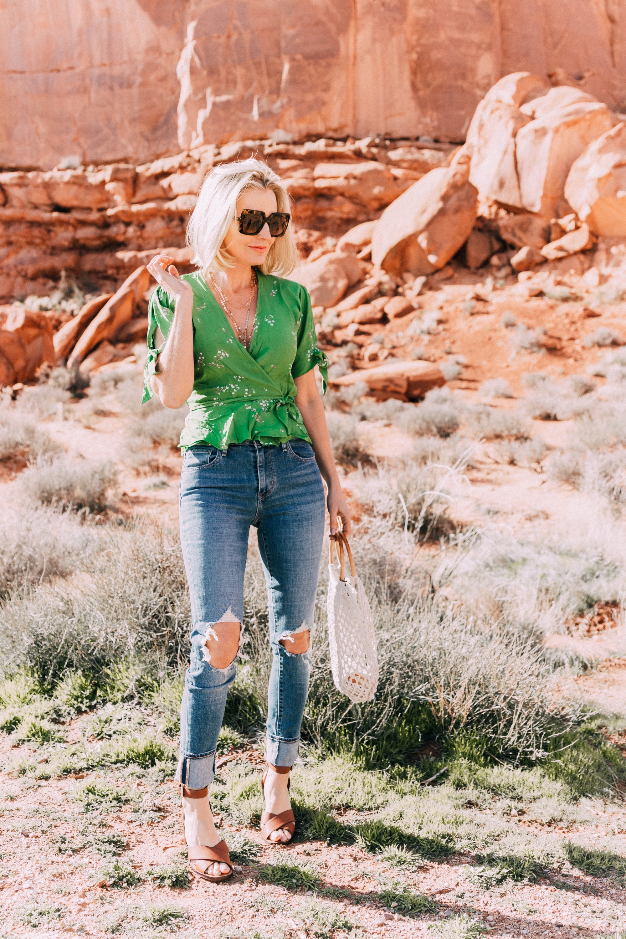 fashion blogger wearing faithfull the brand green lucy wrap top and levi's 721 skinny blue jeans
