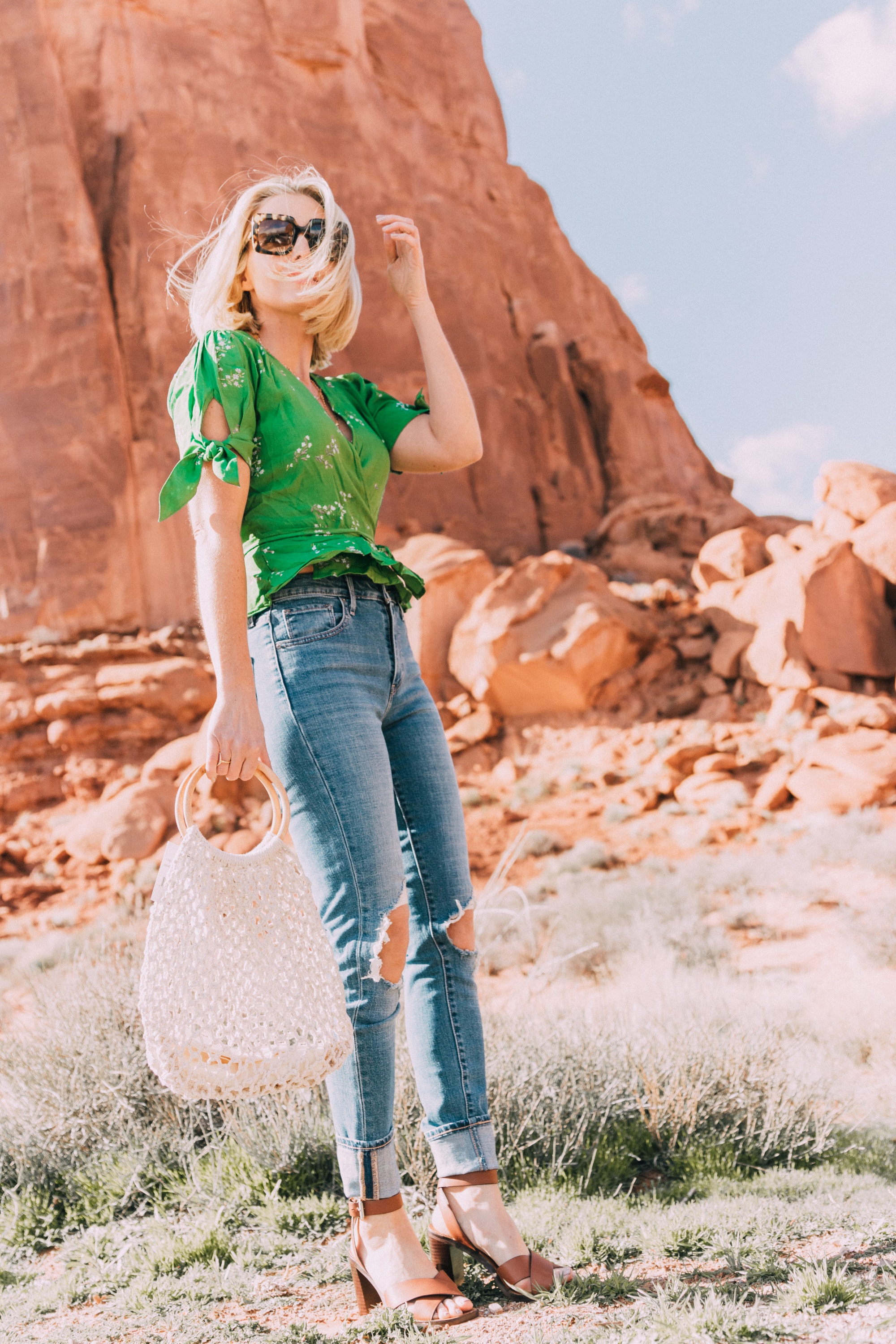 blond fashion blogger wearing faithfull the brand lucy wrap top with levi's 721 jeans and kayu blake rope satchel