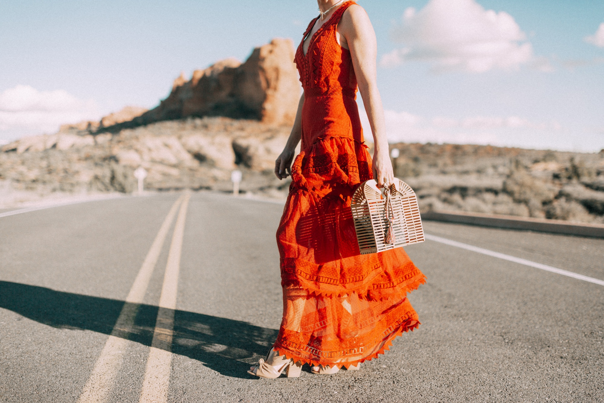 Spring Handbags, Fashion blogger Erin Busbee of BusbeeStyle.com wearing an ornage House of Harlow dress from Revolve with Vince Camuto bamboo basket bag in Moab, Utah