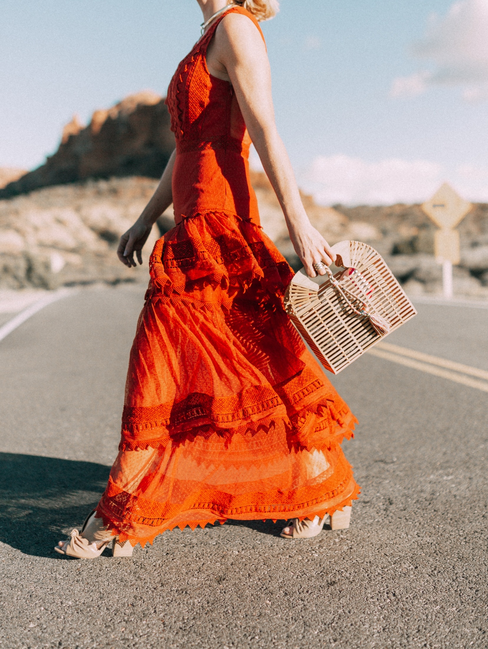Spring Handbags, Fashion blogger Erin Busbee of BusbeeStyle.com wearing an ornage House of Harlow dress from Revolve with Vince Camuto bamboo basket bag, and Vince Camuto nude sandals in Moab, Utah