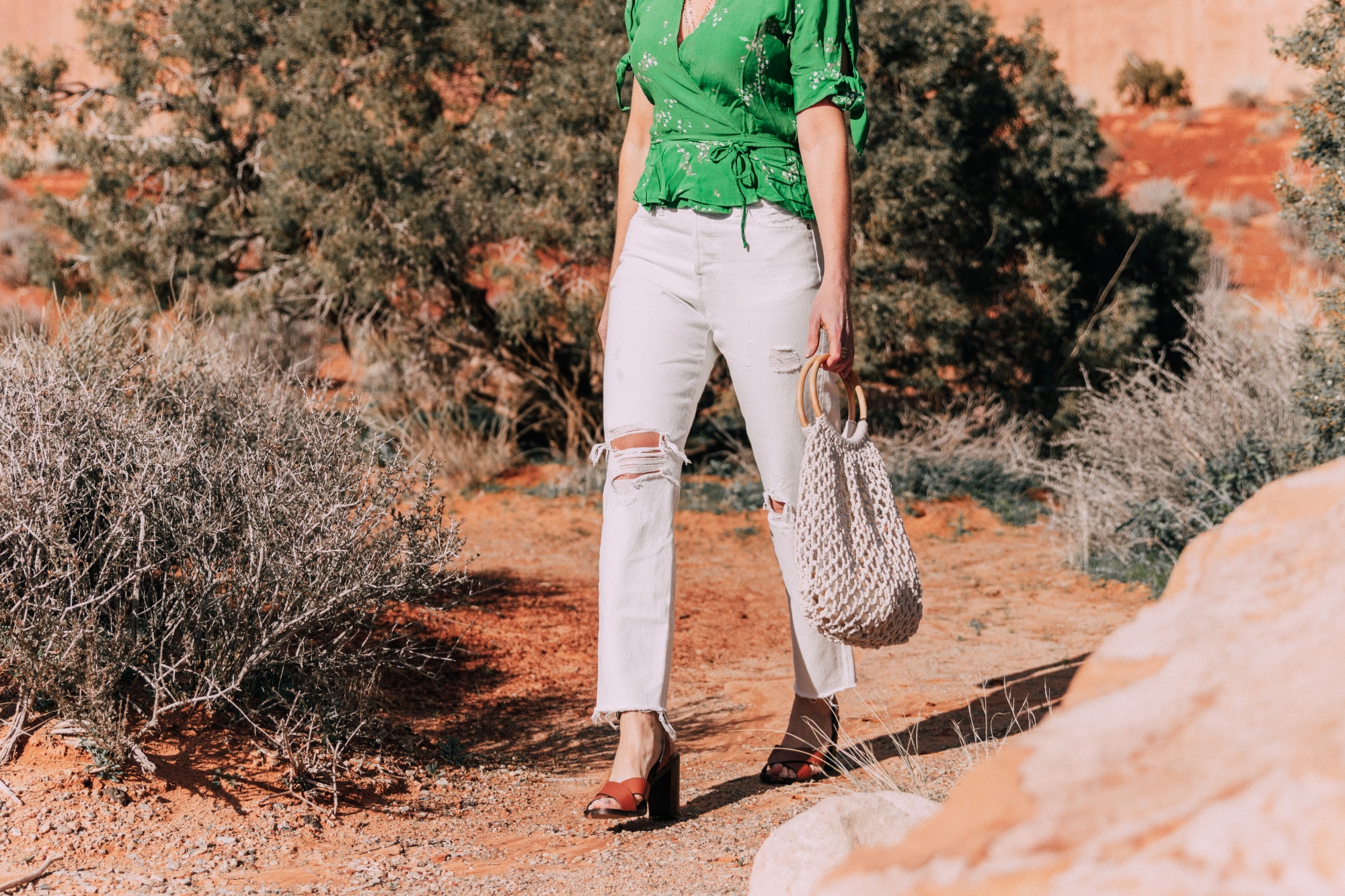 ECO-Friendly clothes featuring the pop-up shop, Good For The Globe, Fashion blogger Erin Busbee of BusbeeStyle.com wearing a green floral Faithfull The Brand top, Kayu rope bag, and Levi jeans from Bloomingdale's in Moab, Utah