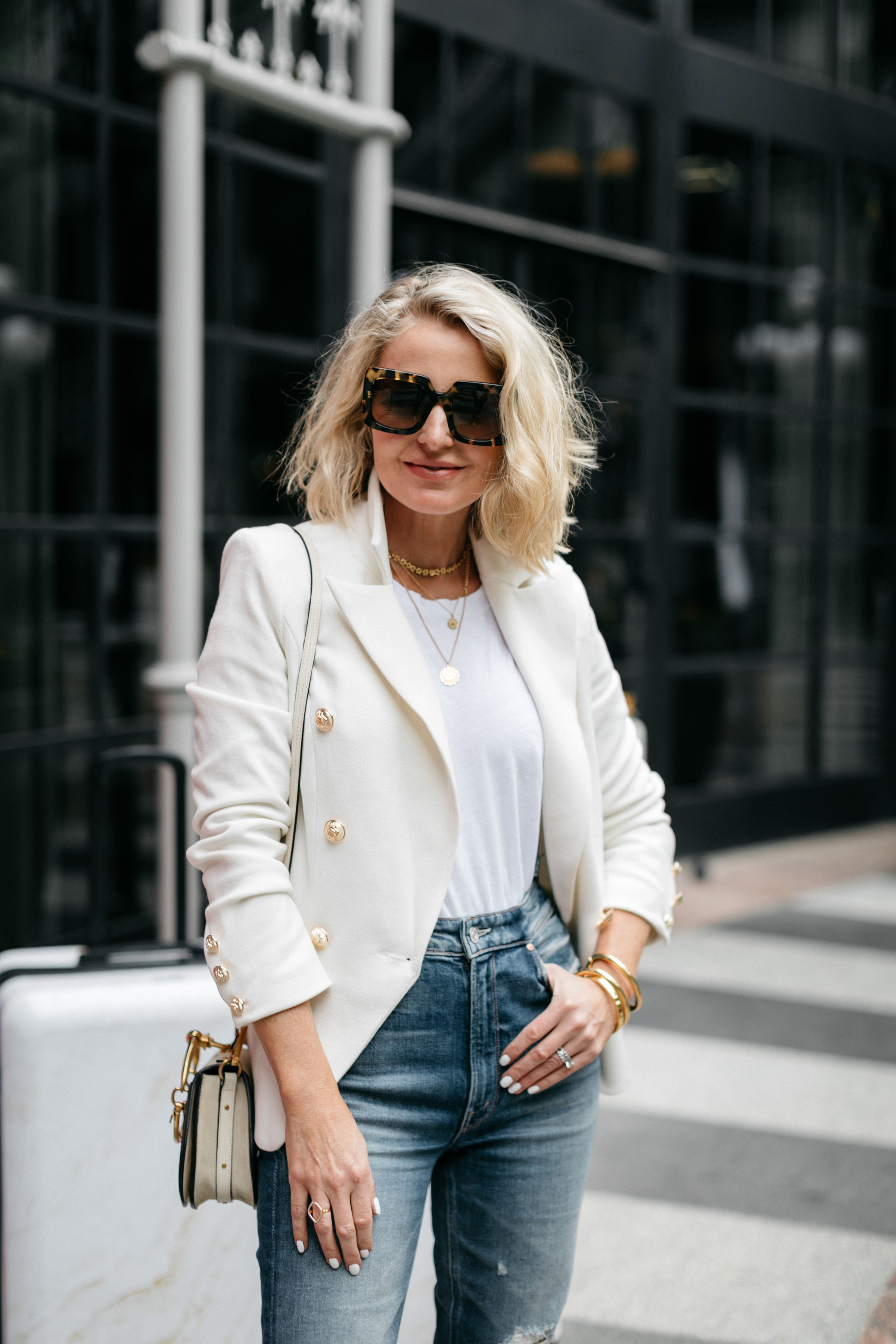 reward style Conference 2019, Fashion blogger Erin Busbee of BusbeeStyle.com wearing jeans, camo sneakers, and a white blazer in Dallas, Texas