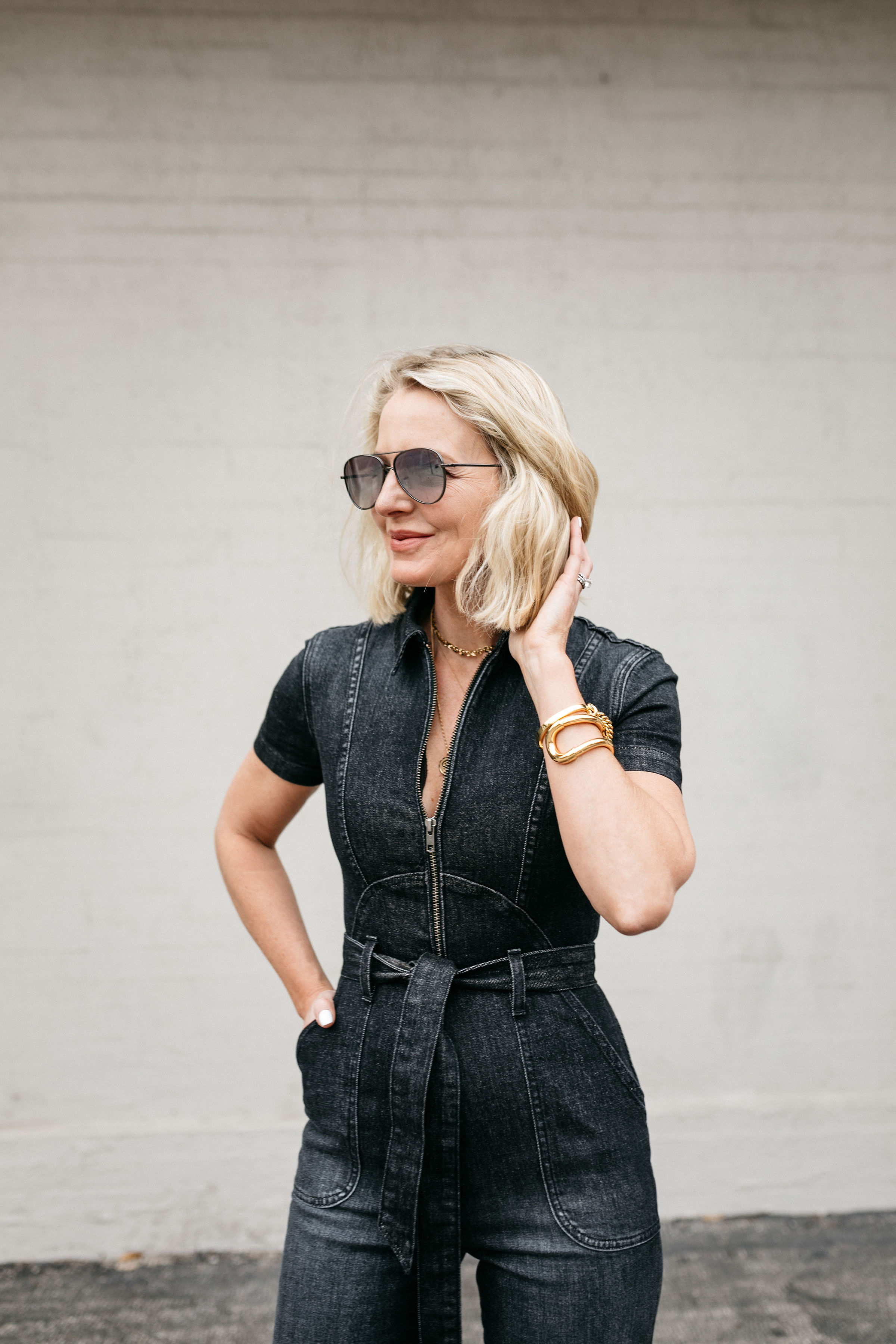 Reward Style Conference 2019, Fashion Blogger Erin Busbee of BusbeeStyle.com wearing an Alice + Olivia black denim jumpsuit in Dallas, Texas