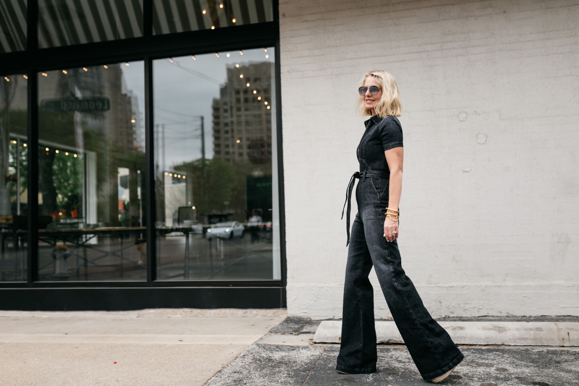 fashion blogger wearing clothing outfit for looking taller in pictures alice and olivia denim jumpsuit