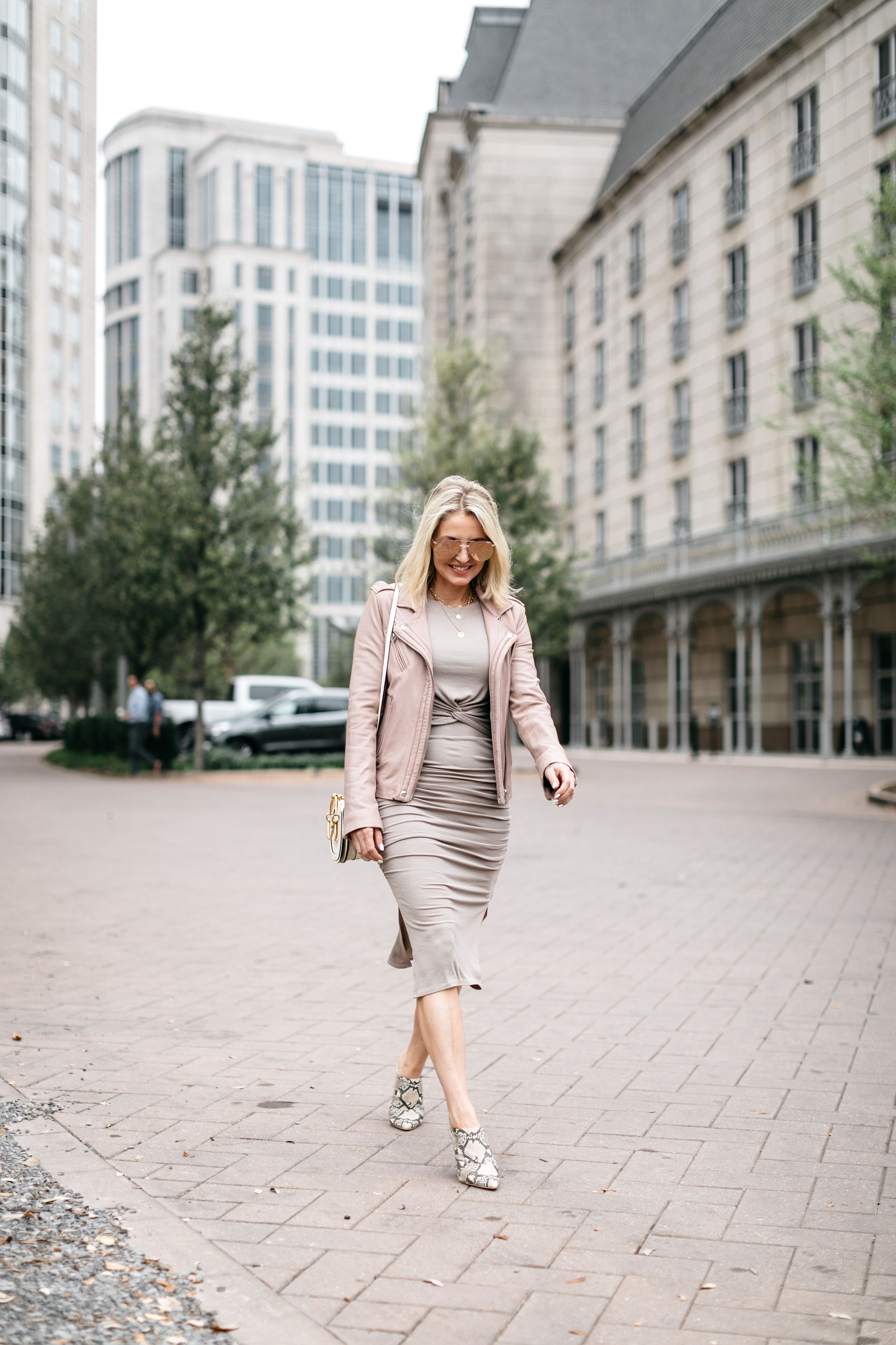 Reward Style Conference 2019, Fashion blogger over 40 Erin Busbee of BusbeeStyle.com wearing a fitted cropped long sleeve top and fitted midi skirt by Made LA from Revolve with an IRO blush leather jacket in Dallas, Texas