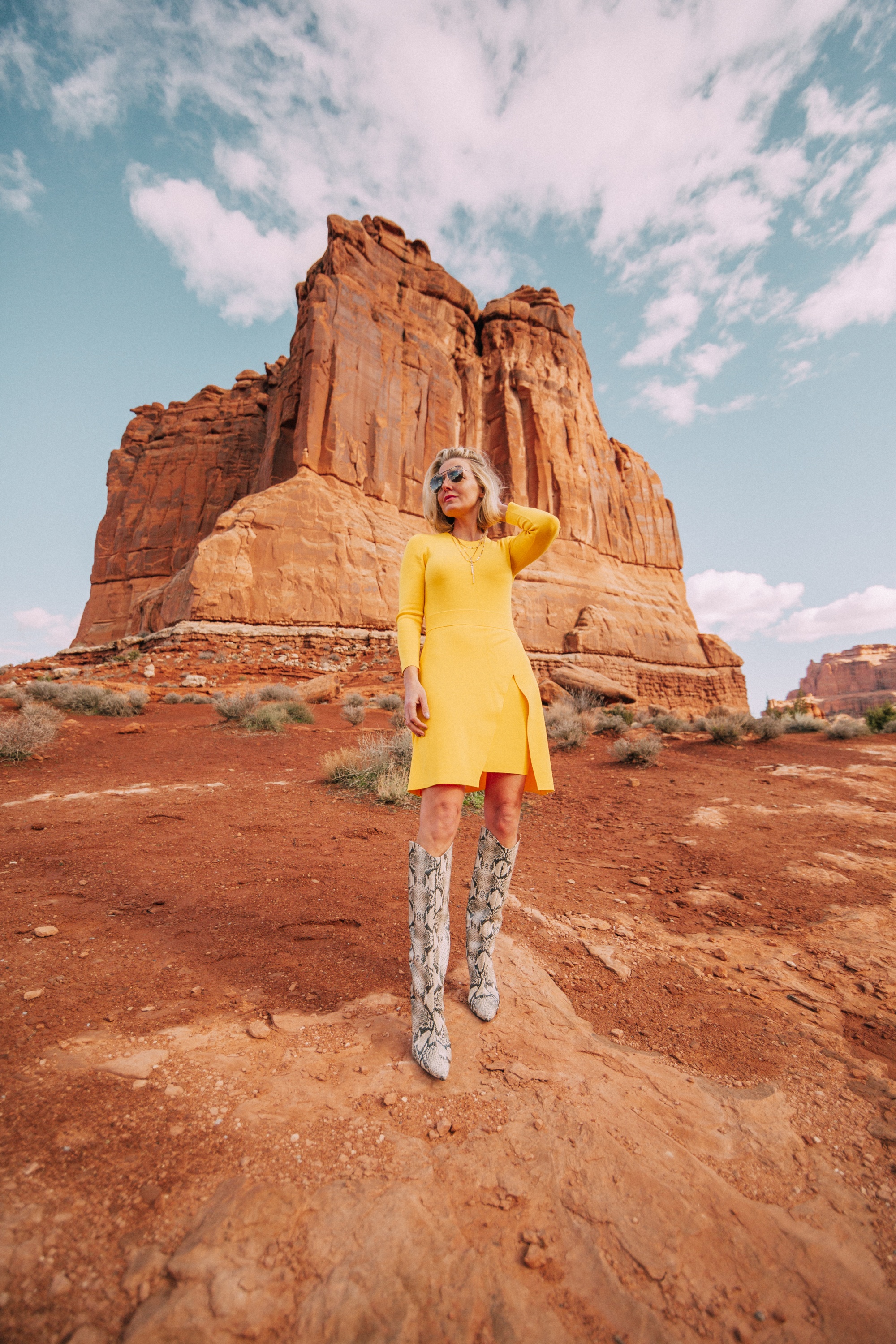 What To Wear To A Spring Wedding, Fashion blogger Erin Busbee of BusbeeStyle.com wearing a yellow long sleeve mini dress by ALC and Schultz python print boots in Moab, Utah