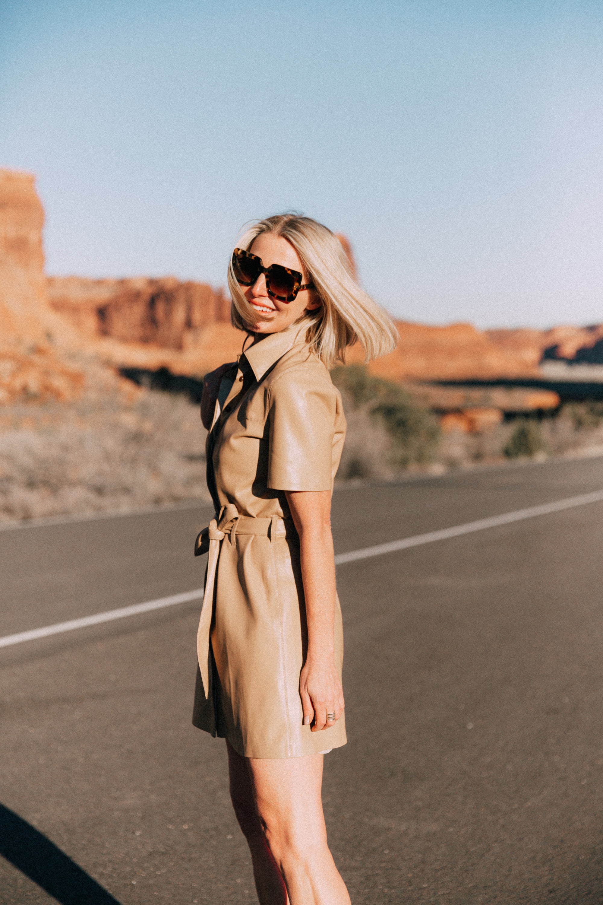 Spring Dresses, Fashion blogger Erin Busbee of BusbeeStyle.com wearing a chic tan leather dress with Dolce Vita python heels and a Lizzie Fortunato bag in Moab, Utah