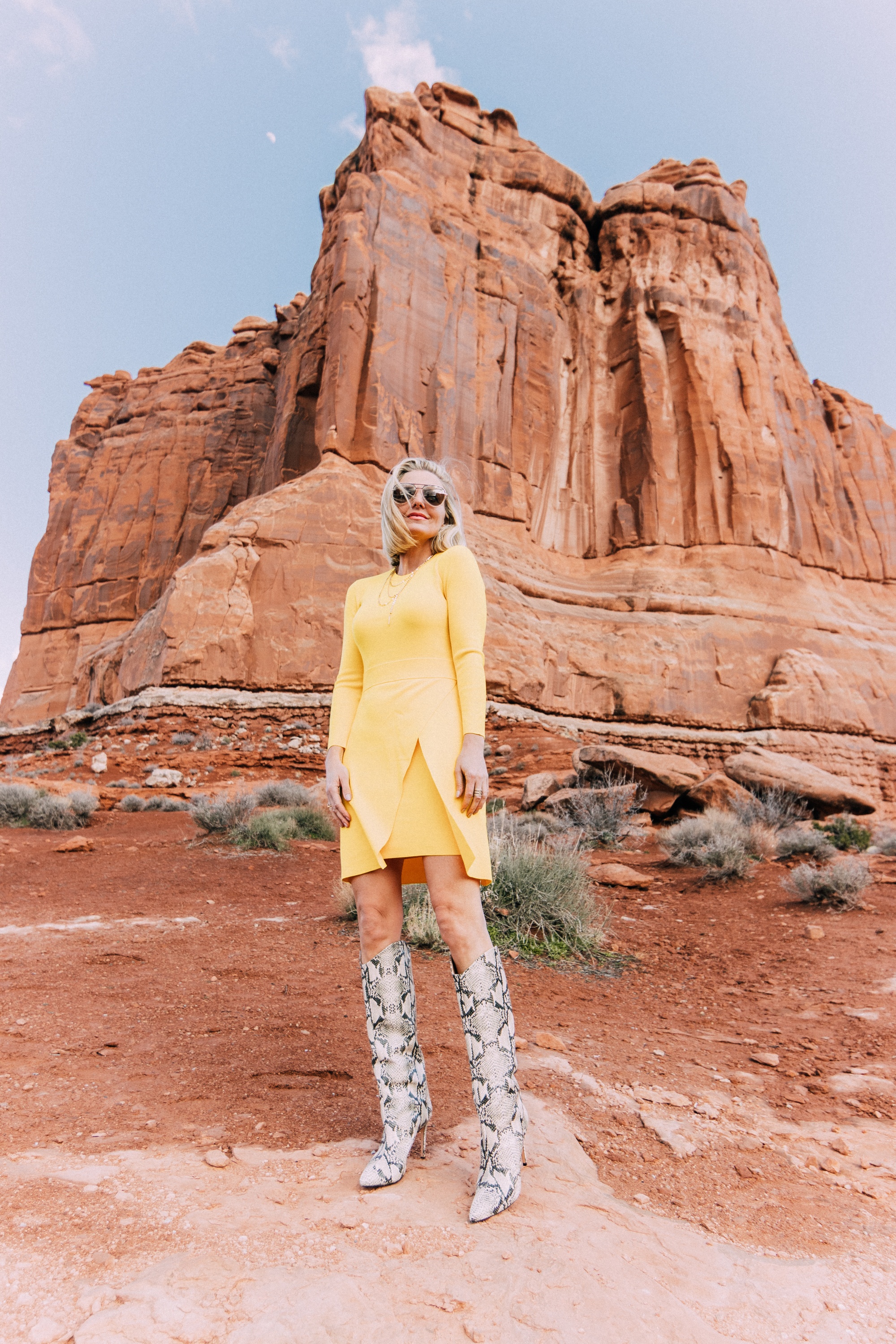 What To Wear To A Spring Wedding, Fashion blogger Erin Busbee of BusbeeStyle.com wearing a yellow long sleeve mini dress by ALC and Schultz python print boots in Moab, Utah