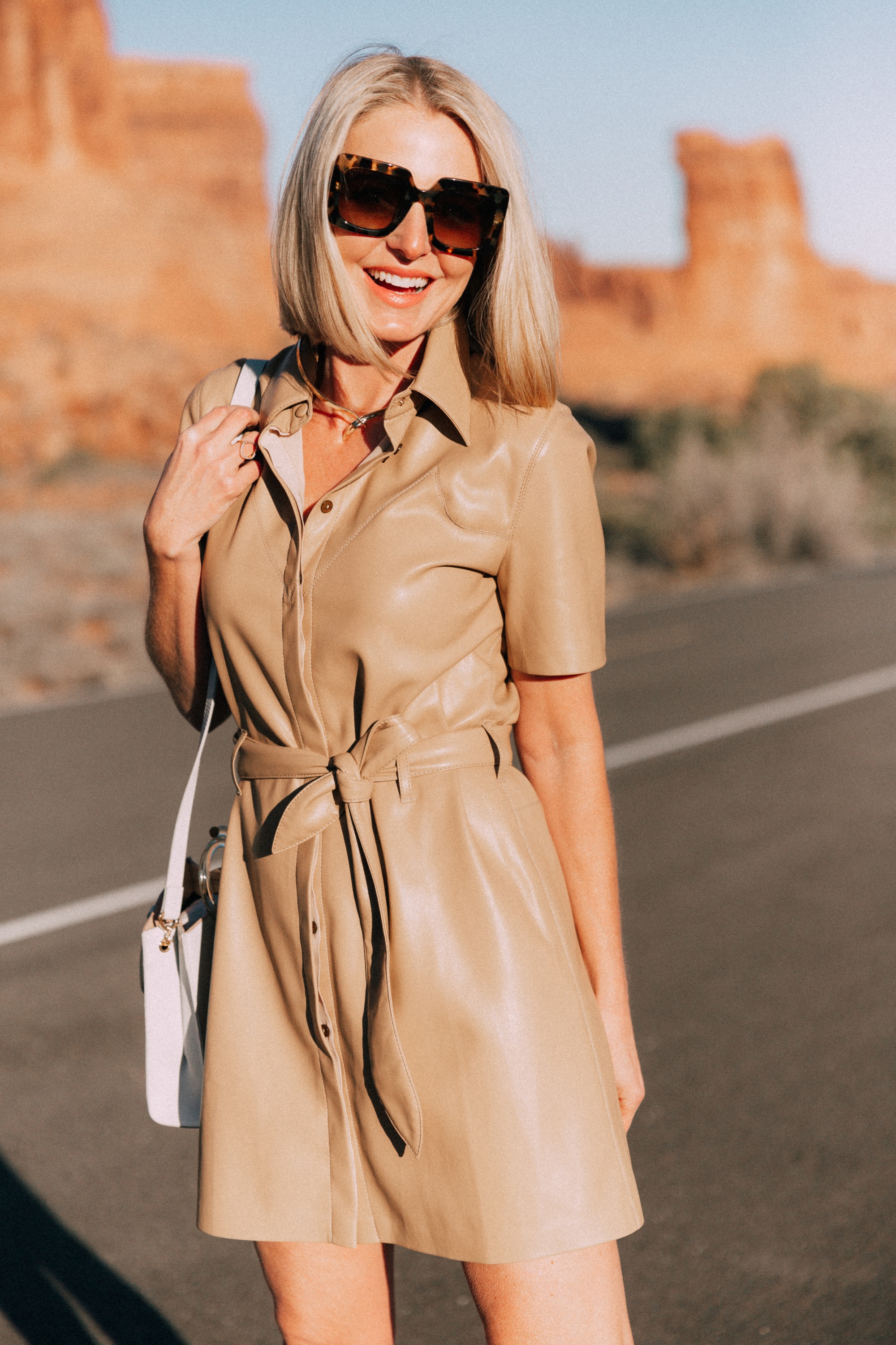 Spring Dresses, Fashion blogger Erin Busbee of BusbeeStyle.com wearing a chic tan leather dress with Dolce Vita python heels and a Lizzie Fortunato bag in Moab, Utah