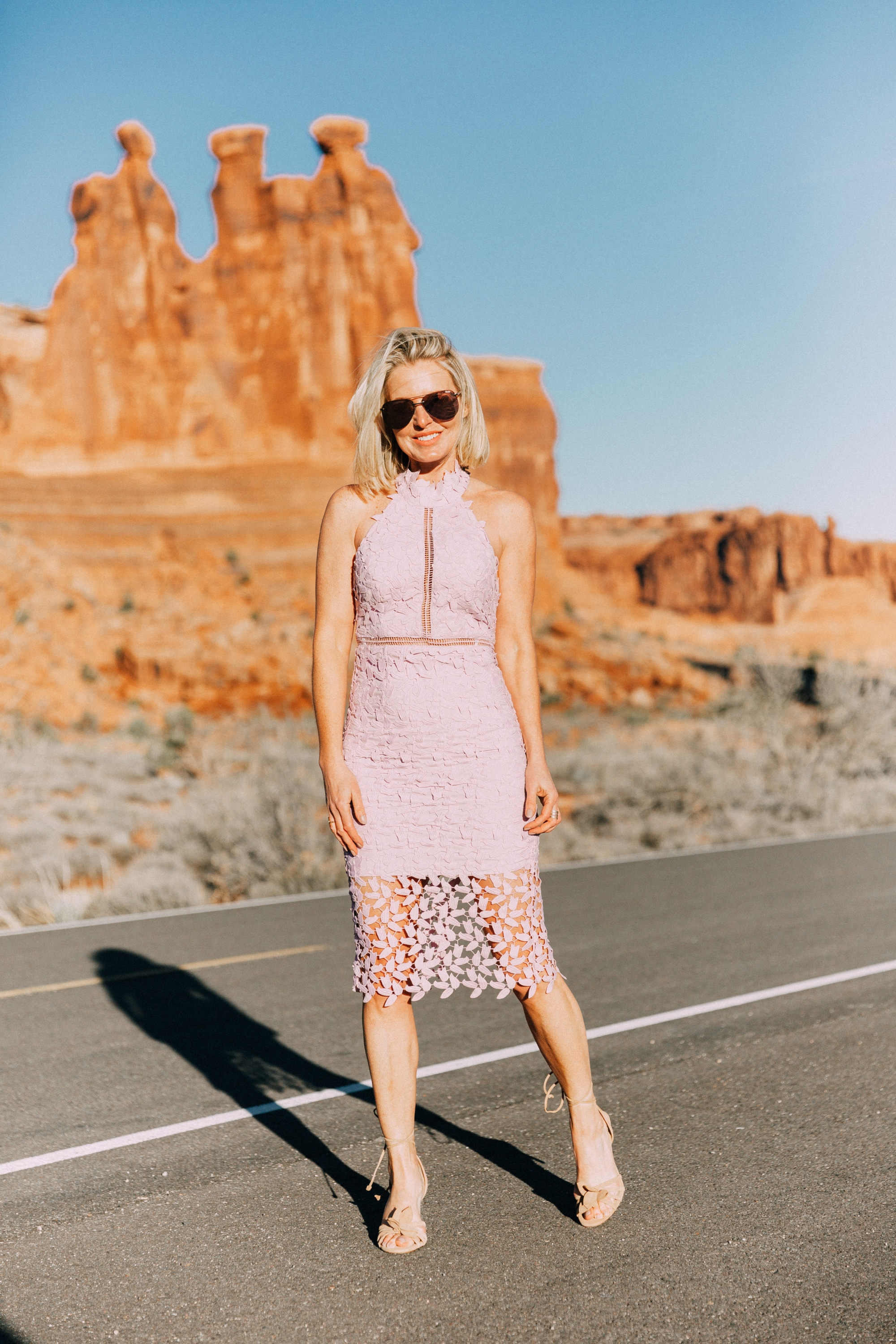 What To Wear To A Spring Wedding, Fashion blogger Erin Busbee of BusbeeStyle.com wearing a lavender lace Bardot dress from Nordstrom with strappy heels from Ann Taylor in Moab, Utah
