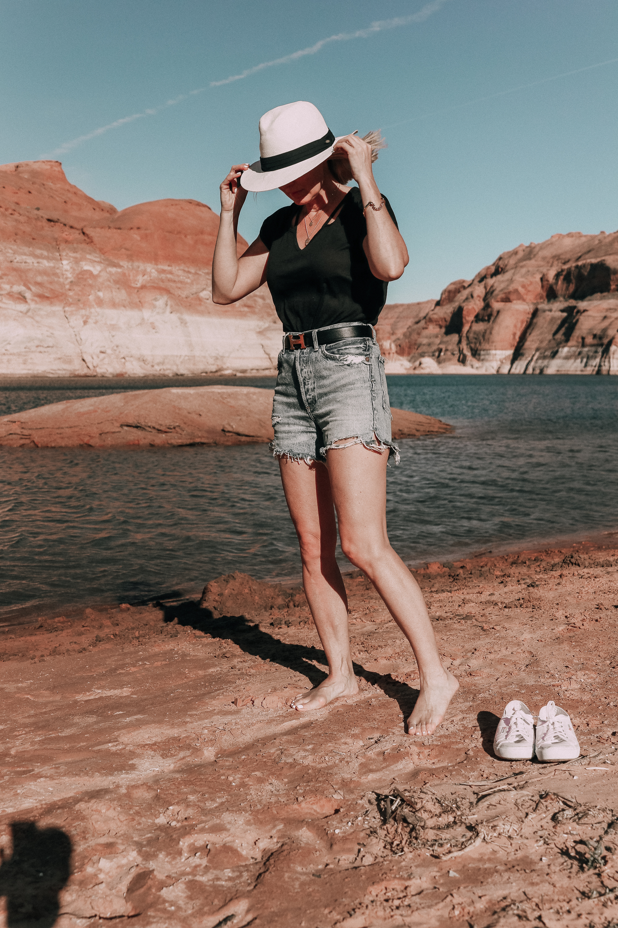 Age Appropriate Denim Shorts, Fashion blogger over 40 Busbee Style wearing AGOLDE denim shorts, a black tee, and panama hat at Lake Powell