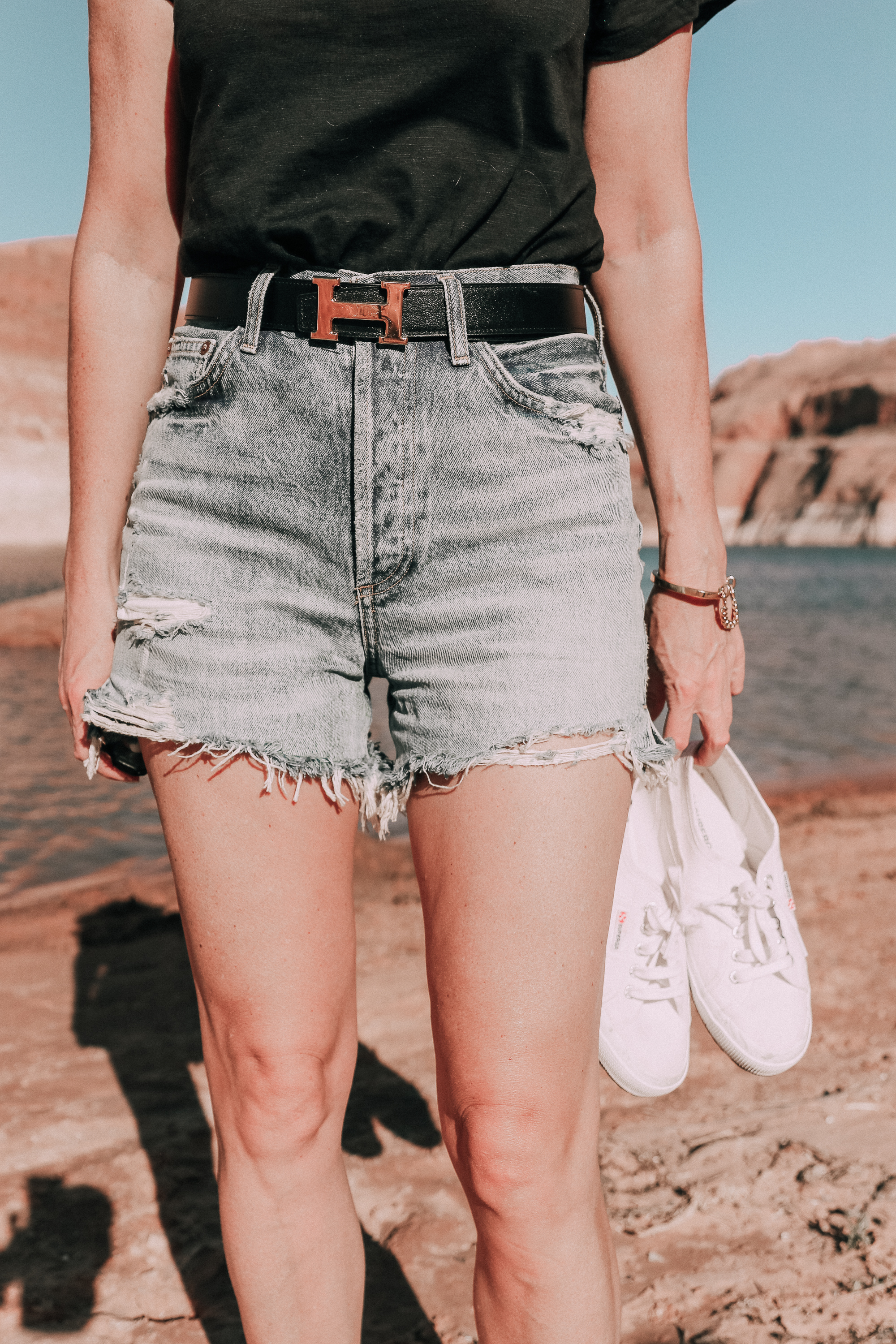 Age Appropriate Denim Shorts, Fashion blogger over 40 Erin Busbee of BusbeeStyle.com wearing AGOLDE denim shorts and a black tee with white Superga sneakers at Lake Powell