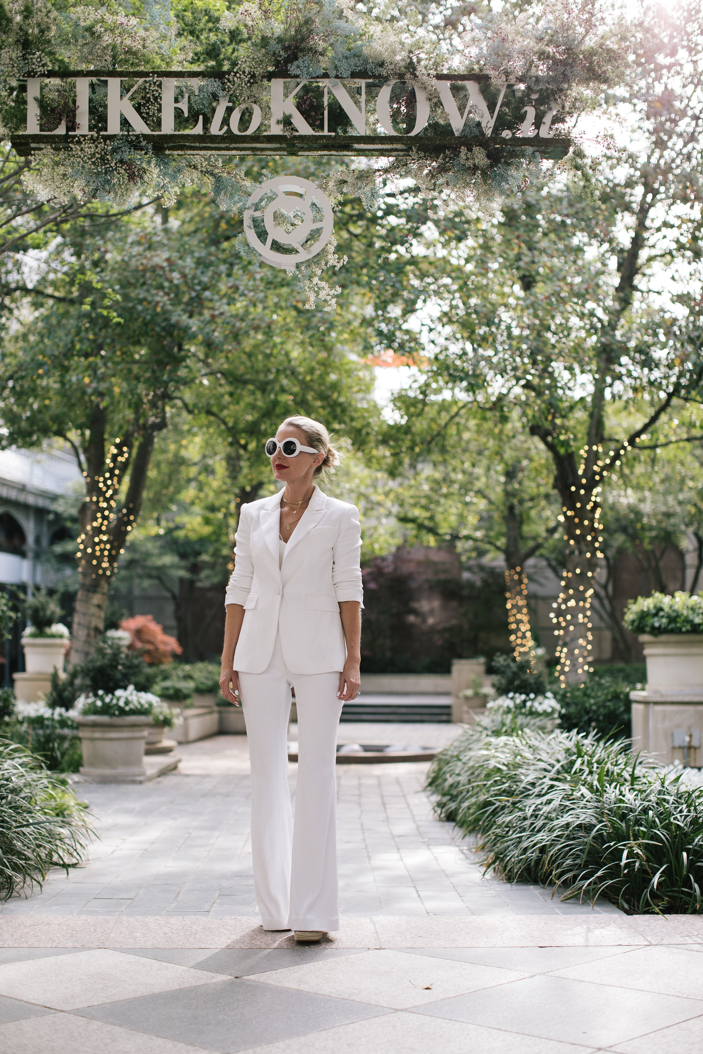 Perfect White Suit, Fashion blogger Erin Busbee of BusbeeStyle.com wearing a matching white sequin blazer and wide leg pants by Rachel Zoe, white pointed toe pumps, and a white chloe nile bag in Dallas, Texas