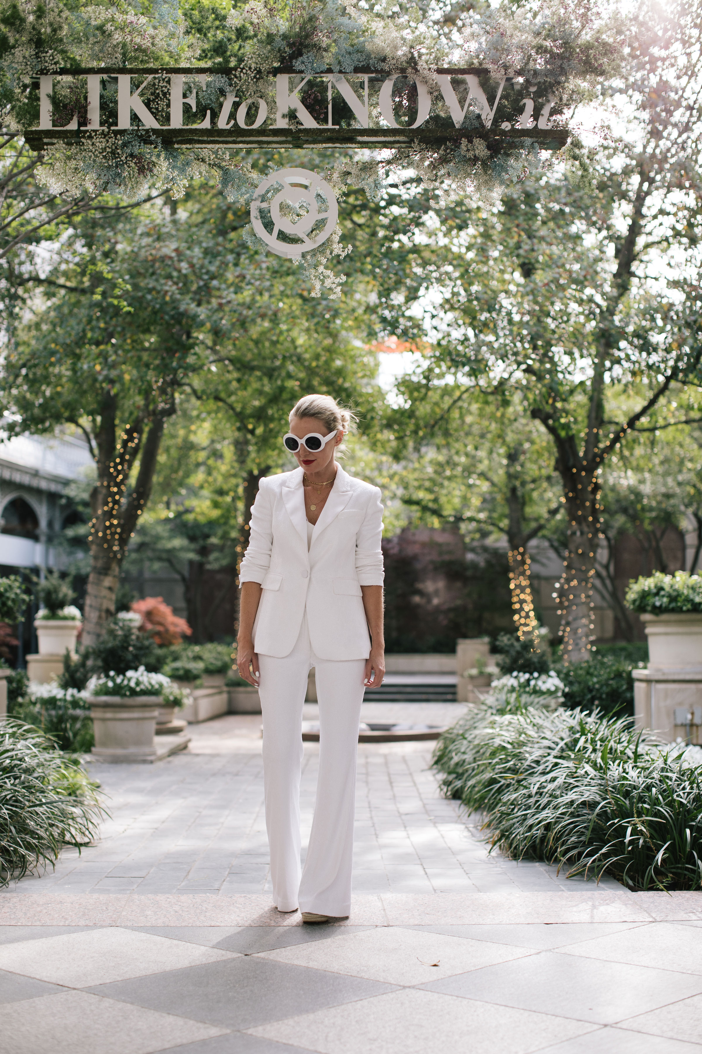 Perfect White Suit, Fashion blogger Erin Busbee of BusbeeStyle.com wearing a matching white sequin blazer and wide leg pants by Rachel Zoe, white pointed toe pumps, and a white chloe nile bag in Dallas, Texas