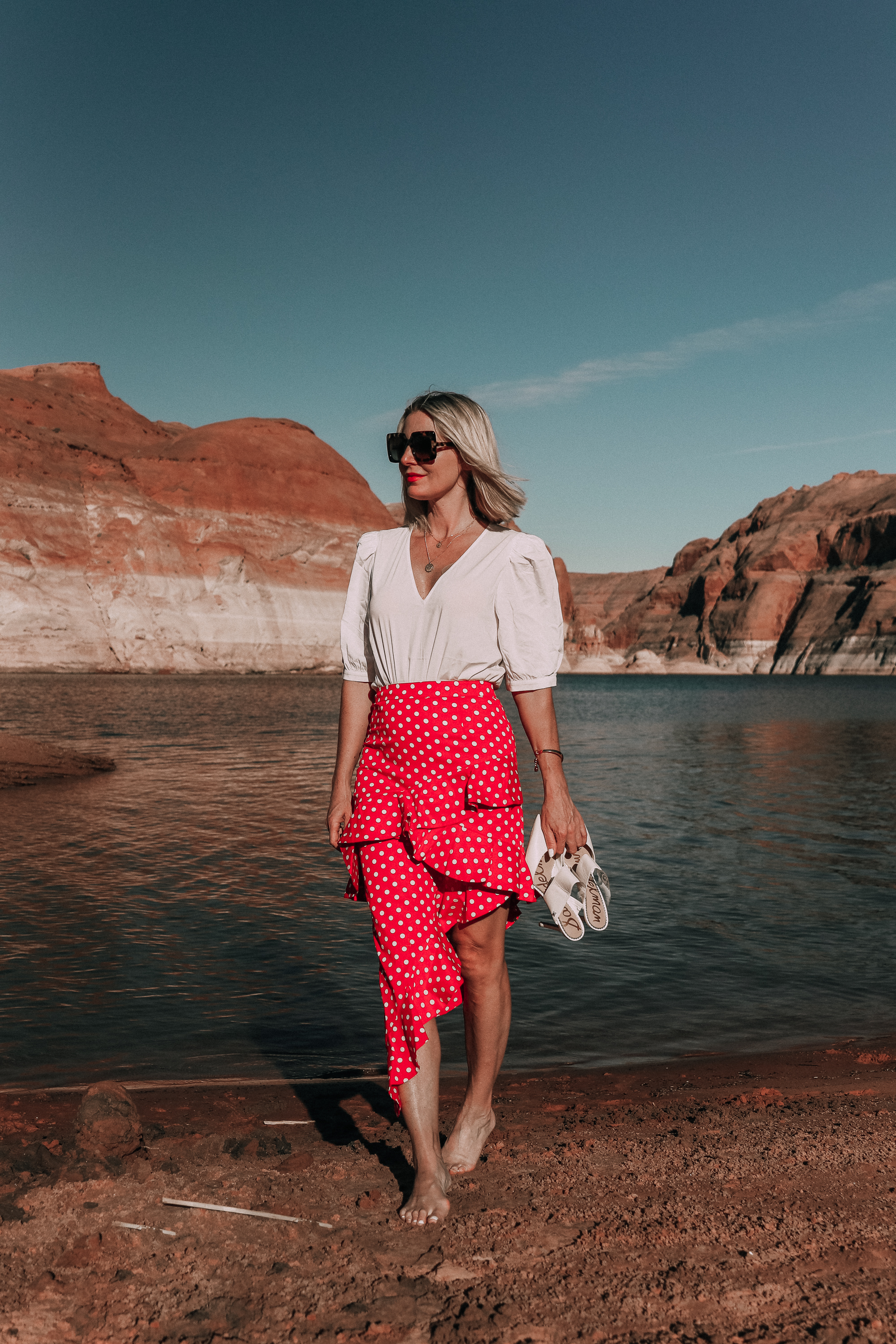 fashion blogger wearing red majorella polka dot ruffle skirt with something navy fitted puff shoulder bodysuit