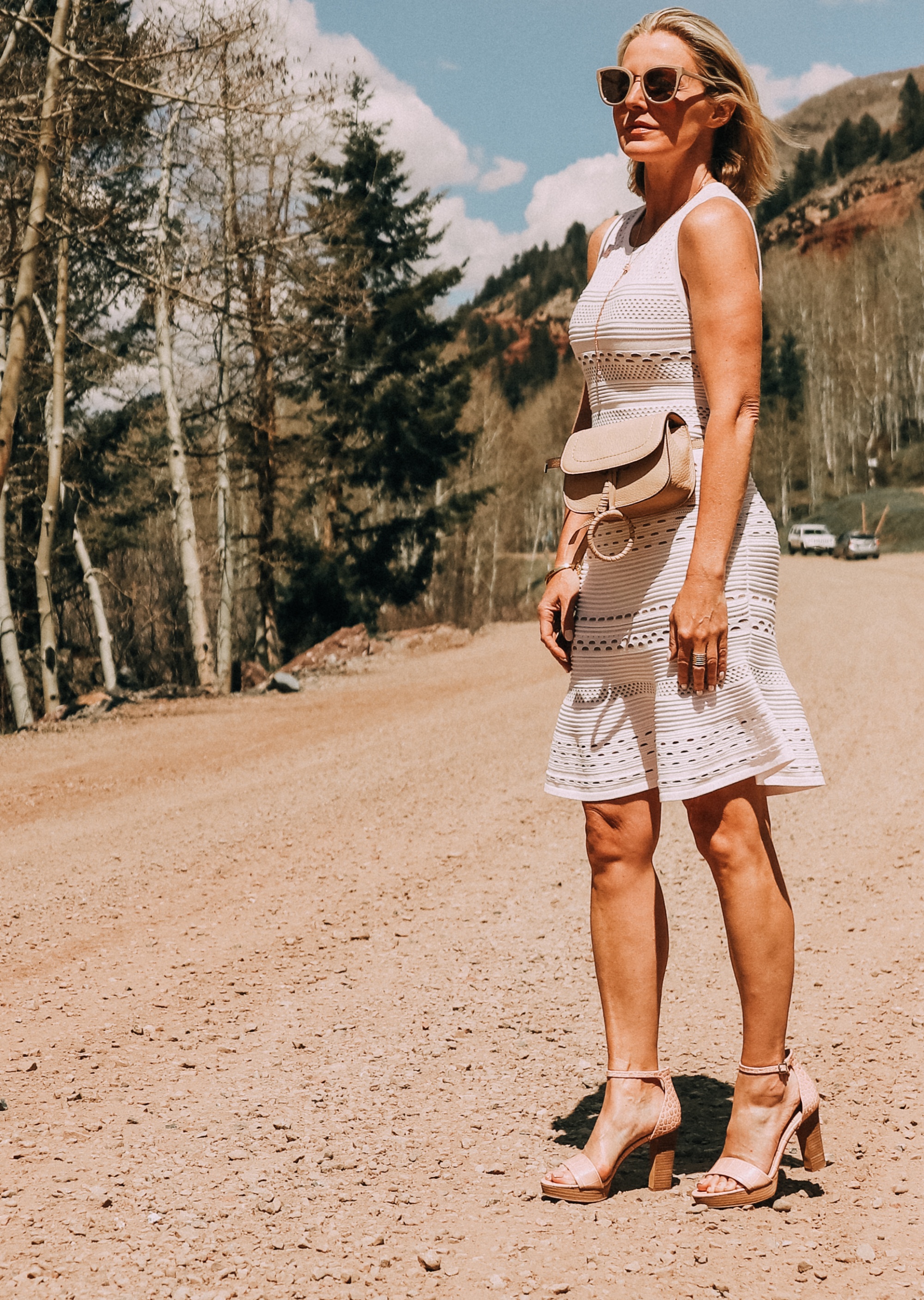 Neutral Accessories, Fashion blogger Erin Busbee of BusbeeStyle.com featuring a beige belt bag, neutral platform sandals, and a lariat necklace by Vince Camuto in Telluride, CO