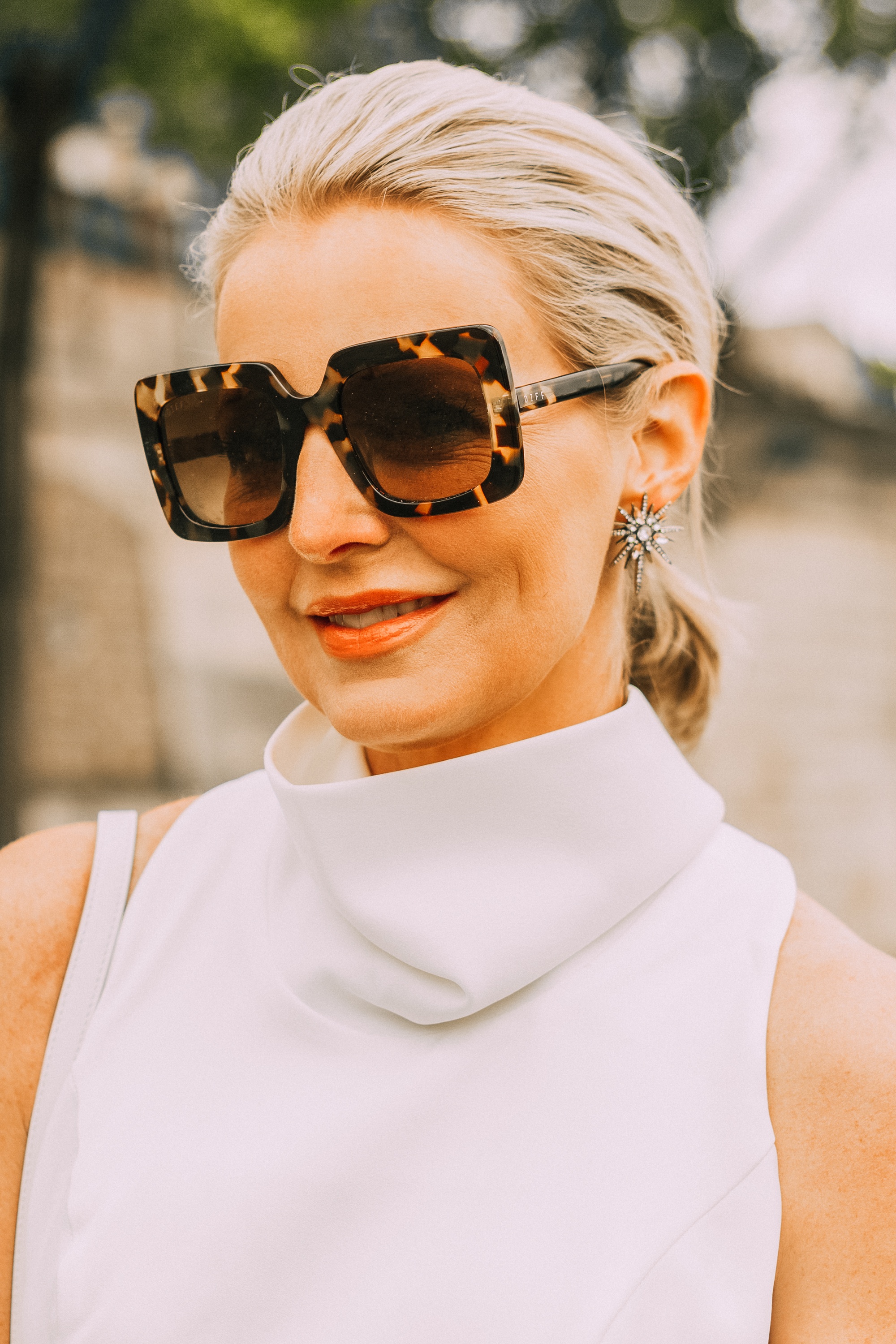 Vow Renewal, Fashion blogger over 40 Erin Busbee of Busbee Style wearing a white jumpsuit by Misha Collection, See By Chloe wedges, and Givenchy bag in Paris, France