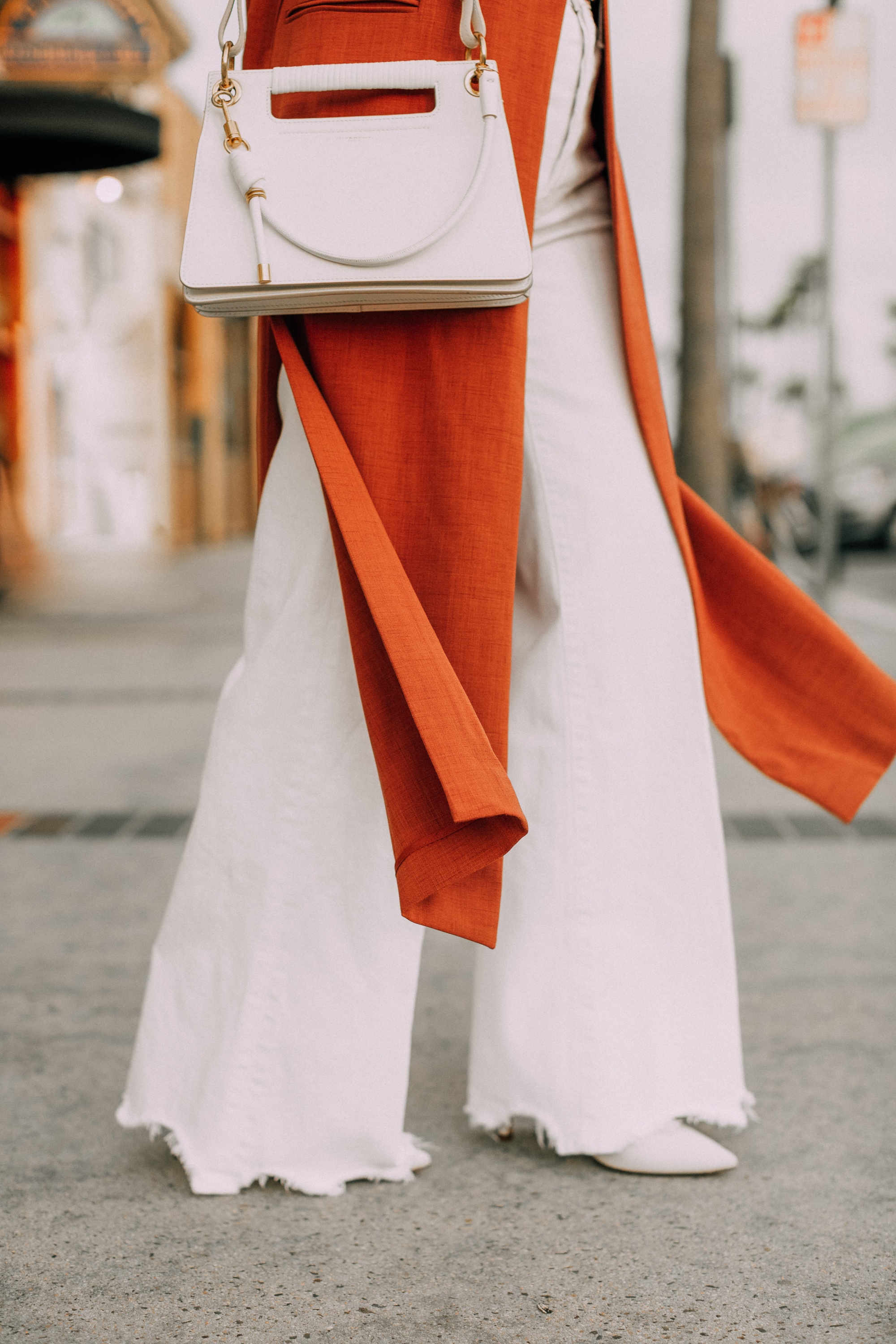 fashion blogger carrying givenchy white small whip handbag with BCBG long vest