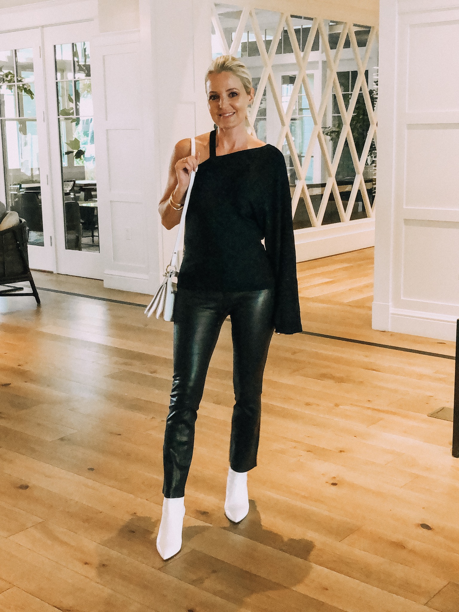 How To Pack Light, fashion blogger wearing rag and bone leather pants Lovers + Friends black sweater Stuart Weitzman white booties in Newport Beach, CA