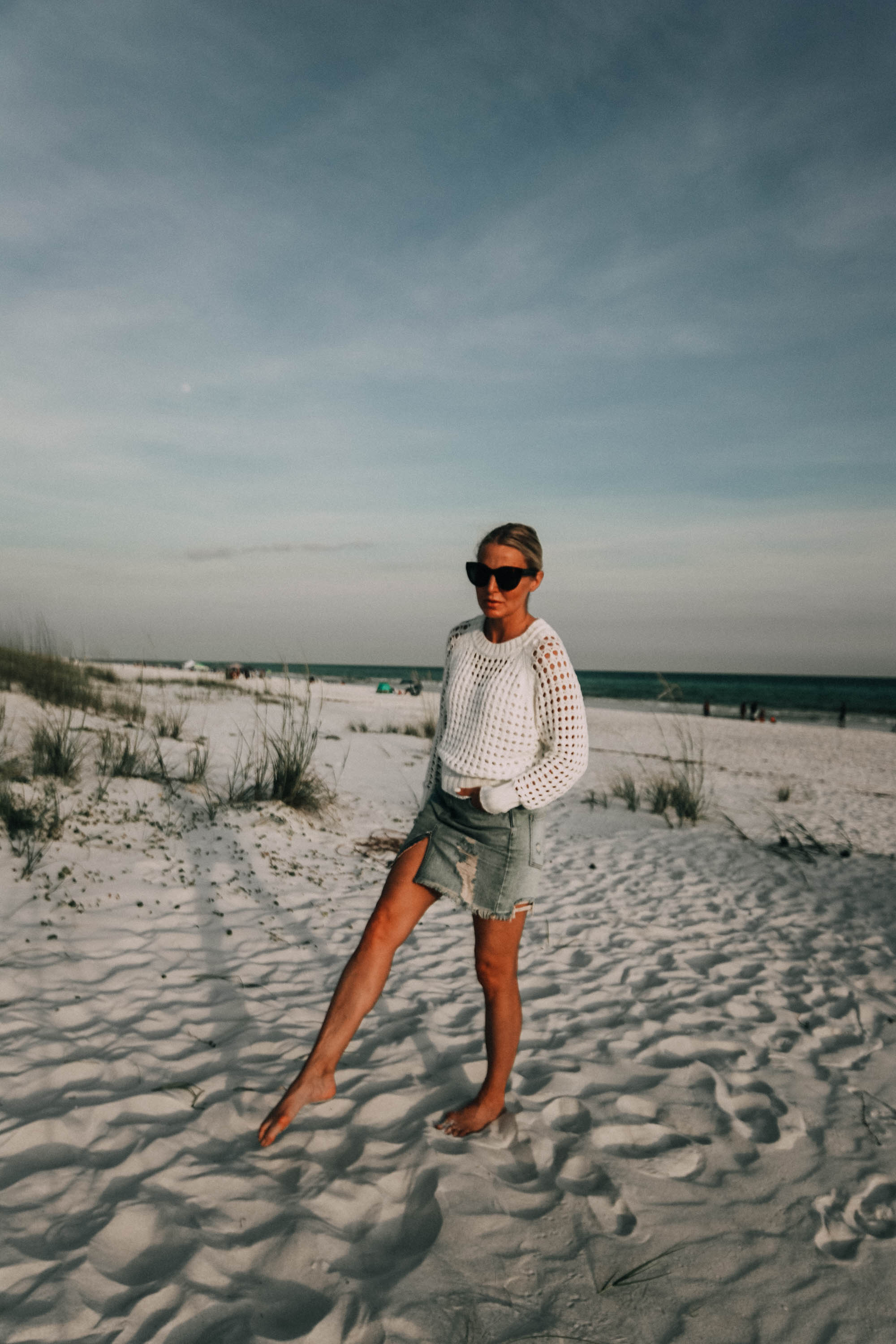 Denim Skirts, Fashion blogger Erin Busbee of BusbeeStyle.com wearing a denim skirt by Free People with a white knit sweater from Nordstrom on the beach in Florida