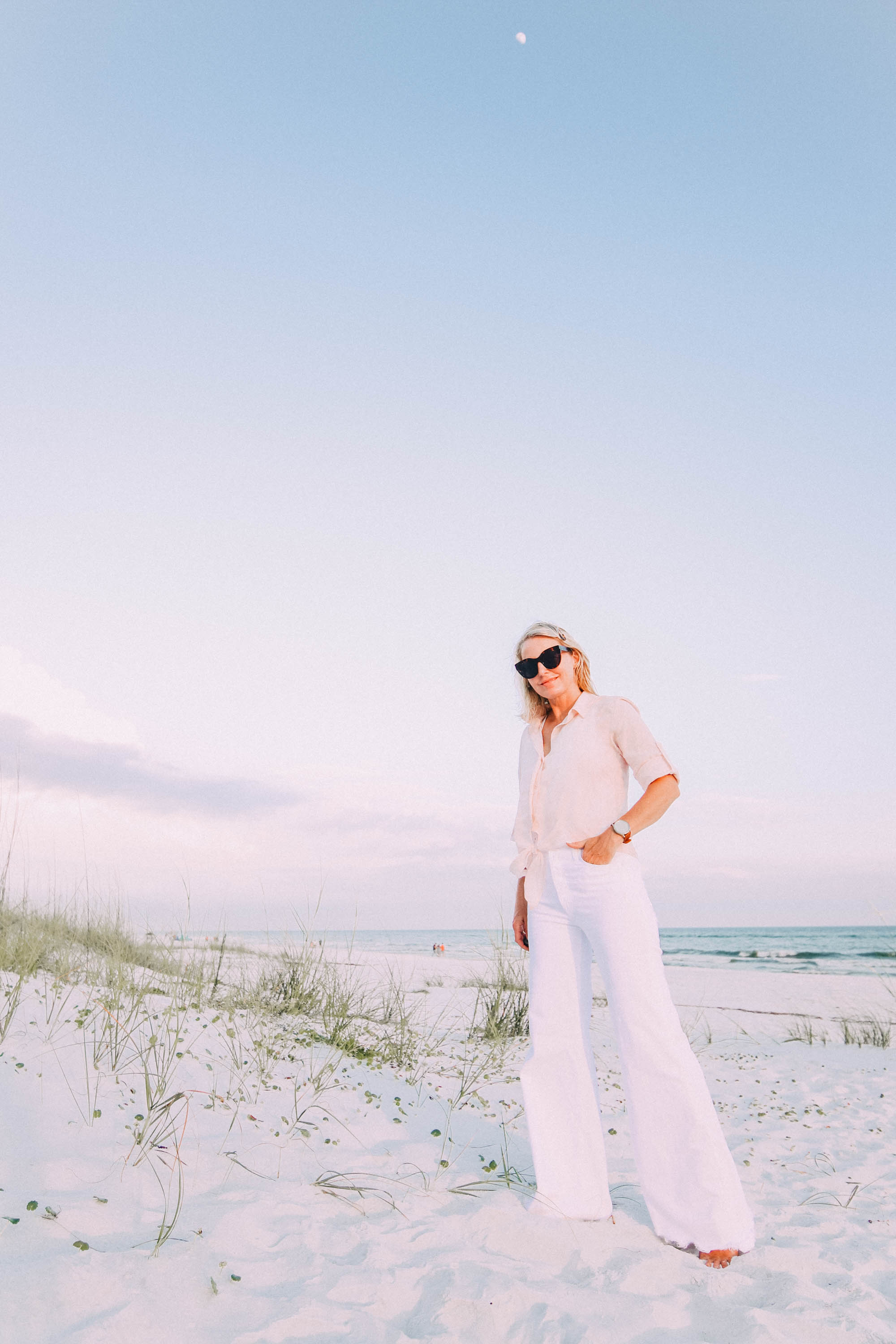 White Jeans For Summer, Fashion blogger Erin Busbee of BusbeeStyle.com wearing white wide leg jeans by Mother with a Bella Dahl pink button up on the beach in Florida