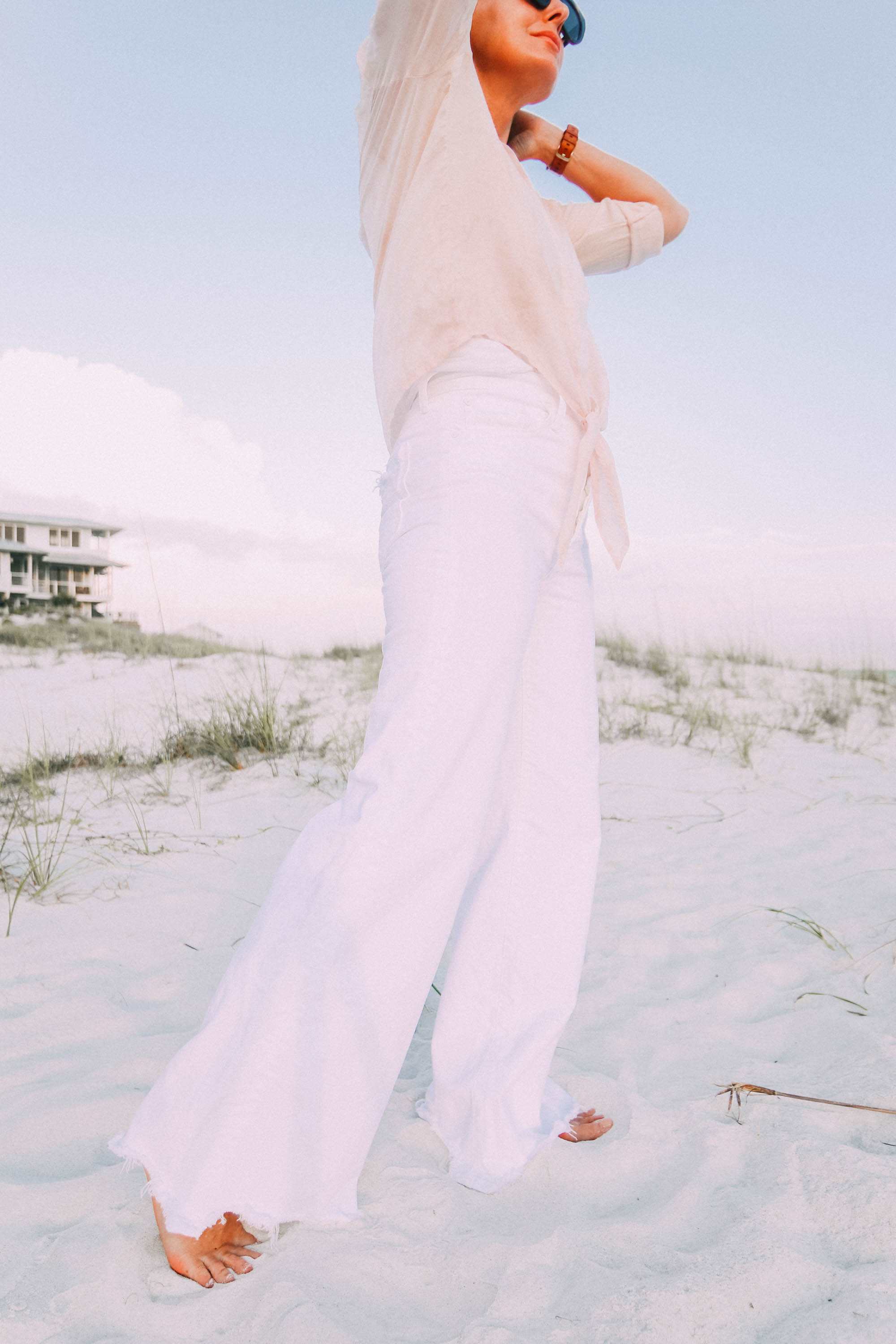 White Jeans For Summer, Fashion blogger Erin Busbee of BusbeeStyle.com wearing white wide leg jeans by Mother with a Bella Dahl pink button up on the beach in Florida