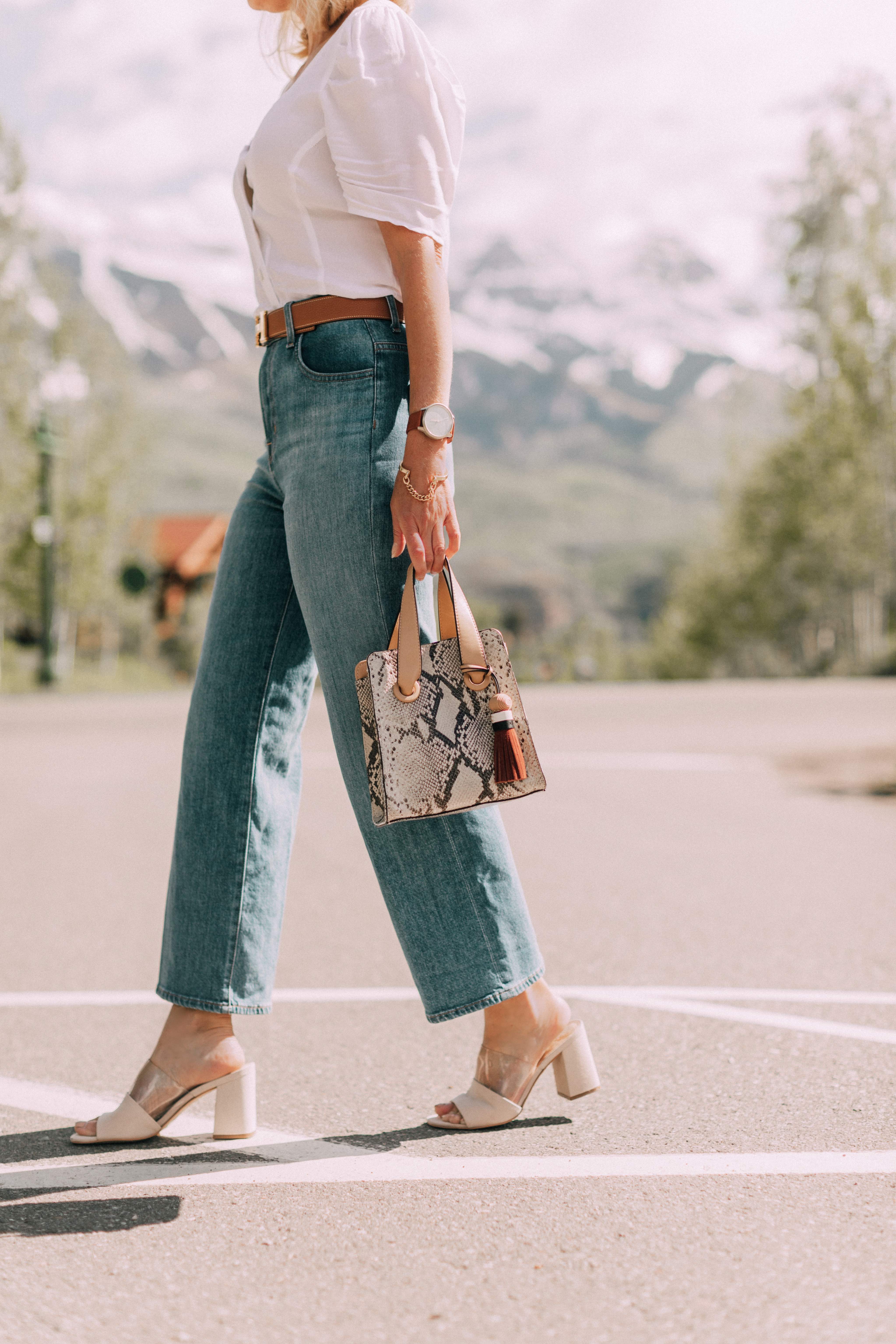 Lucite Trend, Fashion blogger Erin Busbee of BusbeeStyle.com wearing lucite mules from Vince Camuto with J Brand jeans, white Leith top, Hermes belt, and a python print Vince Camuto bag in Telluride, Colorado