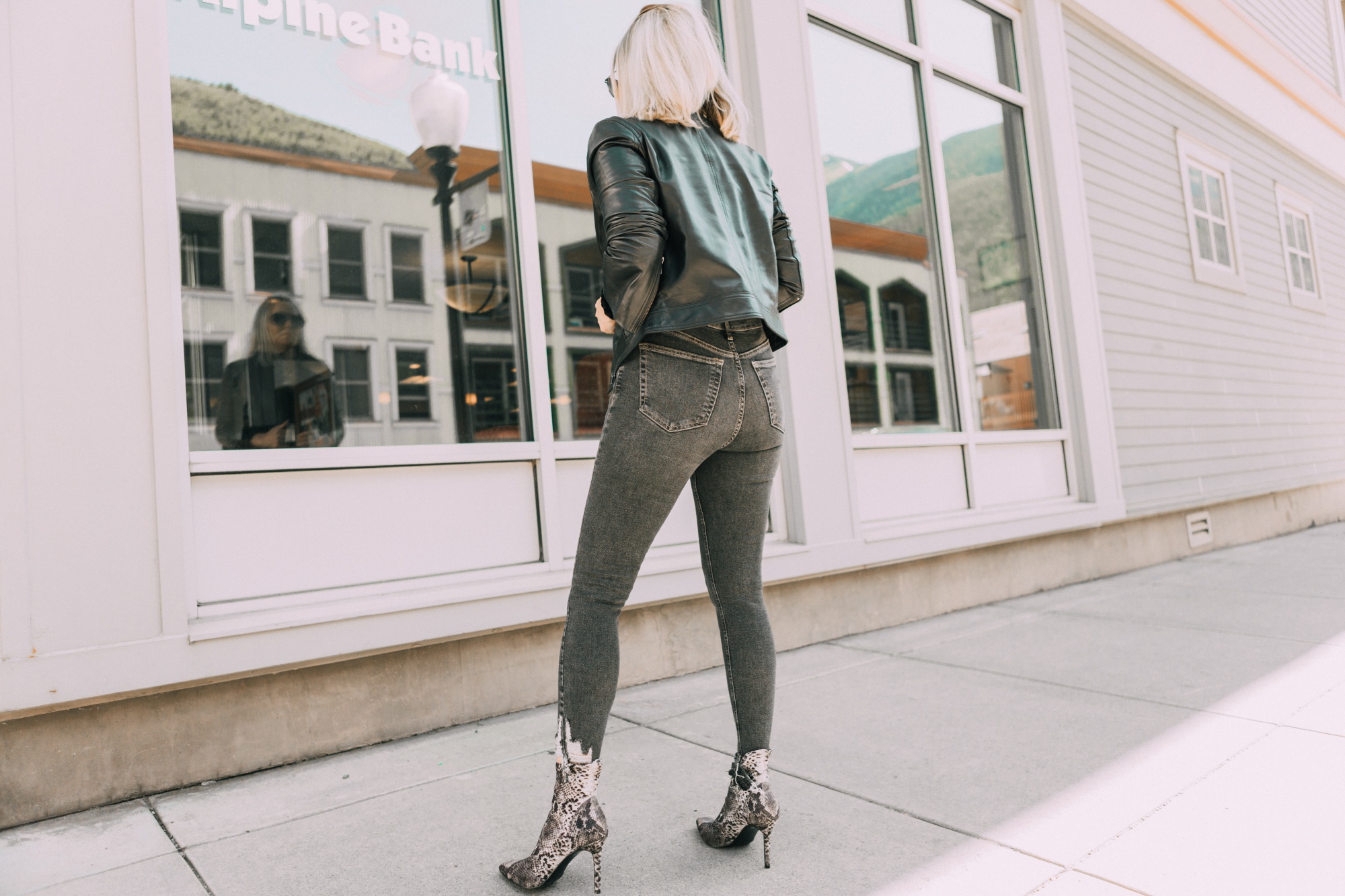 Leather Moto Jacket, Fashion blogger over 40 Erin Busbee of BusbeeStyle.com featuring the Chelsea28 black leather jacket from the Nordstrom Anniversary Sale 2019 styled with the velvet leopard bodysuit, Topshop jeans, and Charles Davidson python print booties from Nordstrom in Telluride, Colorado