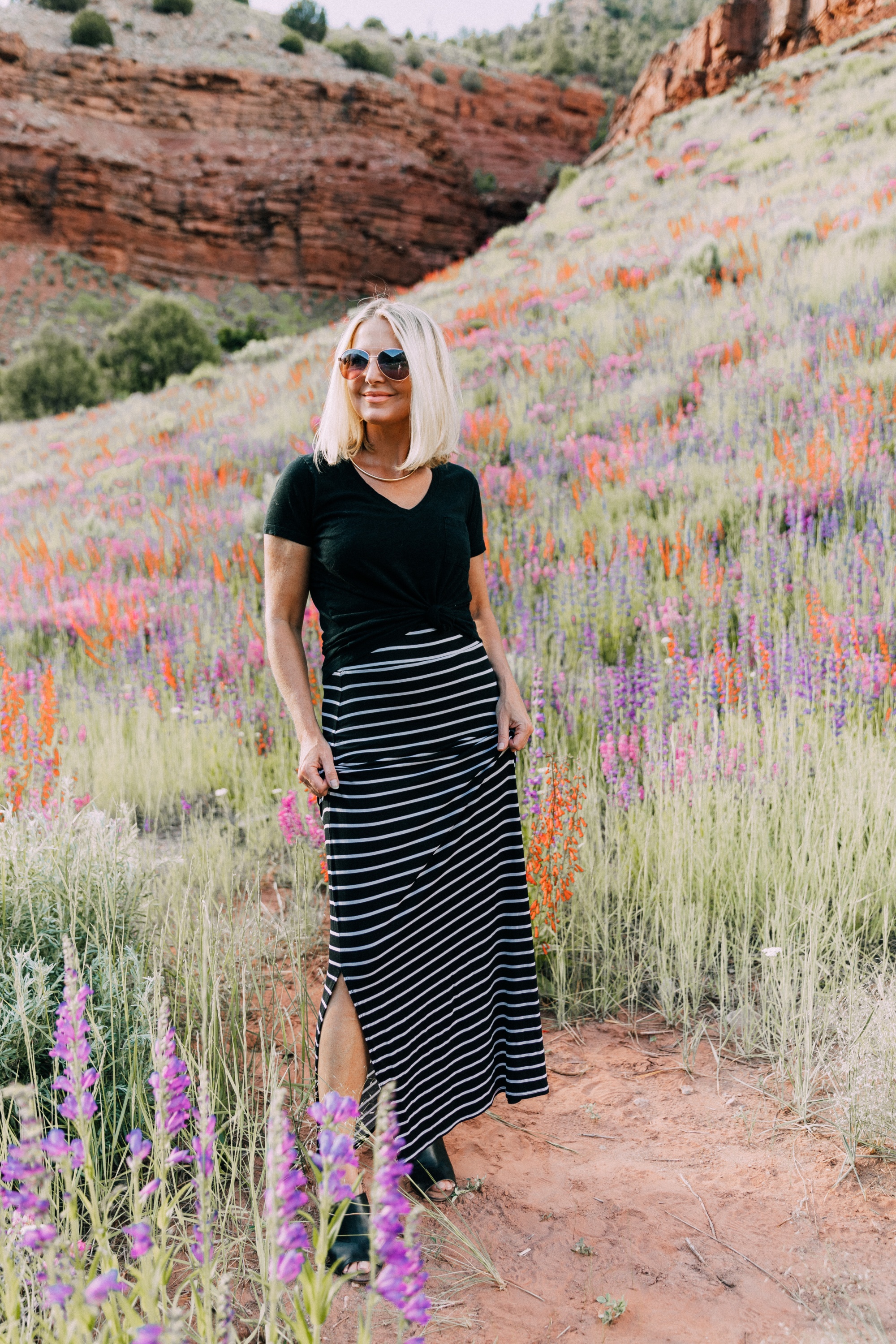 Ways To Wear Stripes, Fashion blogger Erin Busbee wearing a striped maxi skirt, black v-neck tee, and black peep toe mules from JCPenney in the wildflowers in Telluride, CO