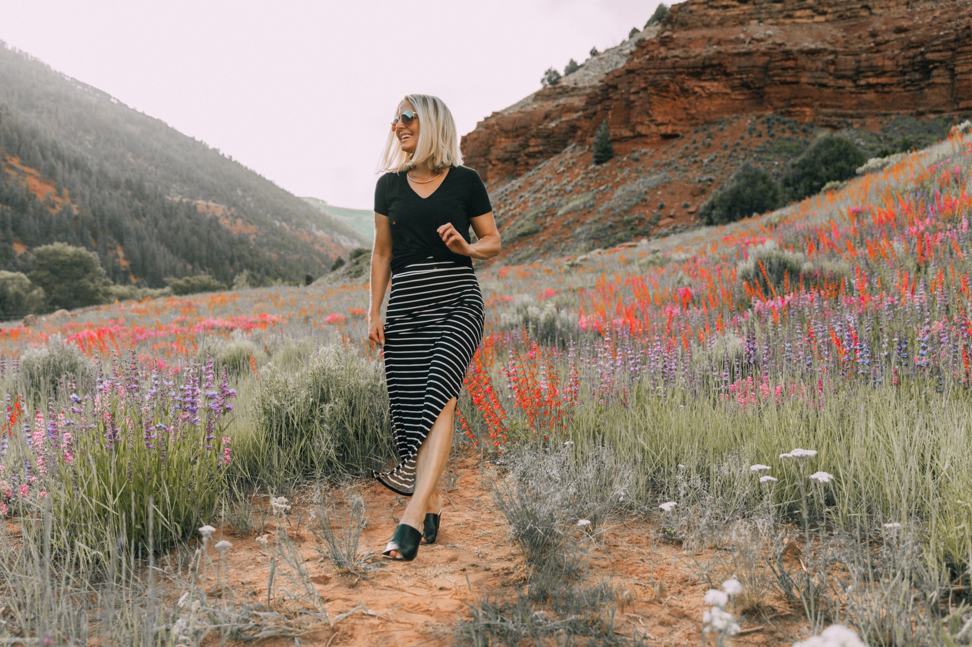 Ways To Wear Stripes, Fashion blogger Erin Busbee of BusbeeStyle.com wearing a striped maxi skirt and black tee from JCPenney with black peep toe mules by Liz Claiborne in the wildflowers in Telluride, CO
