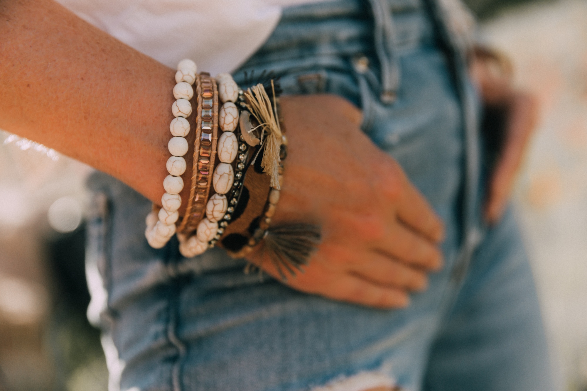 Victoria Emerson, Fashion blogger Erin Busbee of BusbeeStyle.com wearing a marble face watch, pearl wrap bracelet, brown leather wrap bracelet, and Cairo cuff from Victoria Emerson in Telluride, CO