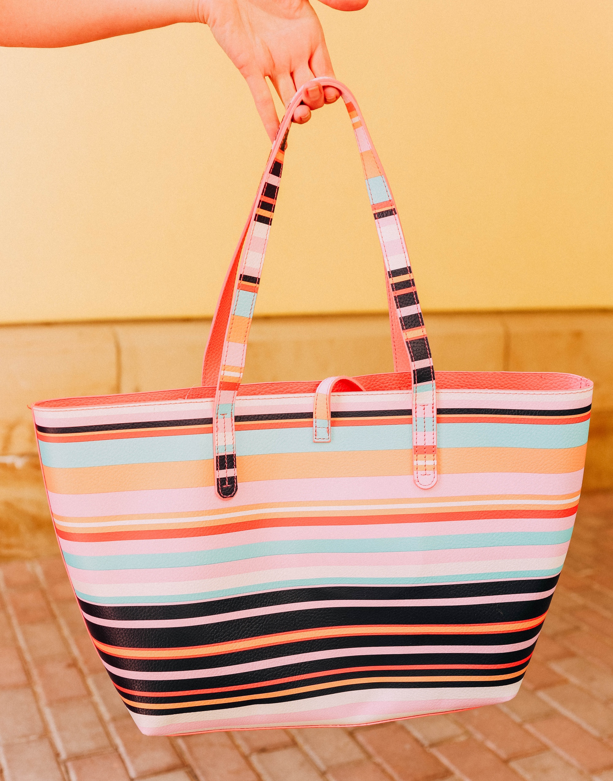 Affordable Swimwear, Fashion blogger Erin Busbee of BusbeeStyle.com wearing a pink high-low off the shoulder dress with a reversible striped tote bag from Walmart