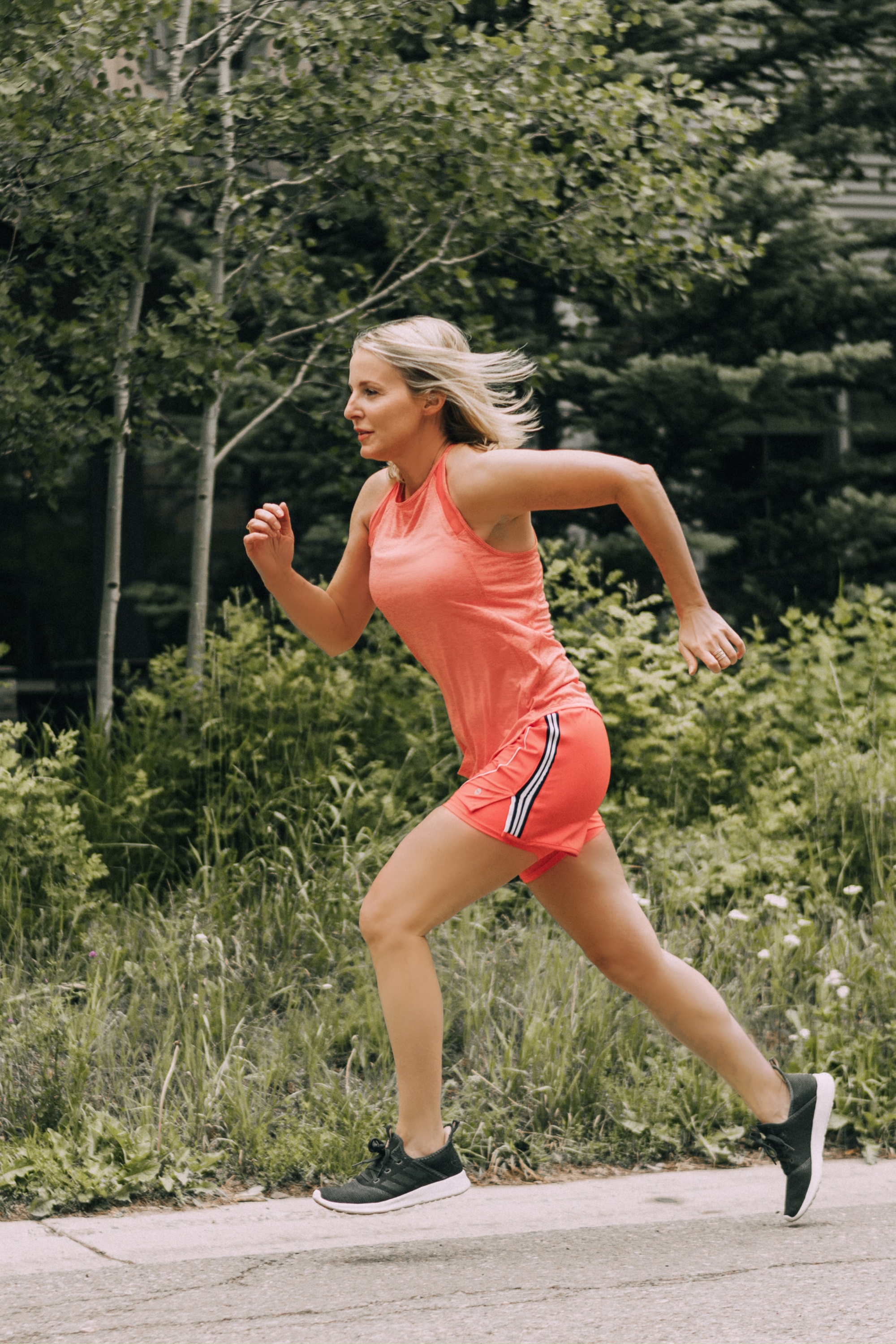 Affordable Activewear From Walmart, Fashion blogger Erin Busbee of BusbeeStyle.com wearing pink shorts with a racing stripe by Avia, pink tank and sports bra by Athletic Works from Walmart running in Telluride, Colorado