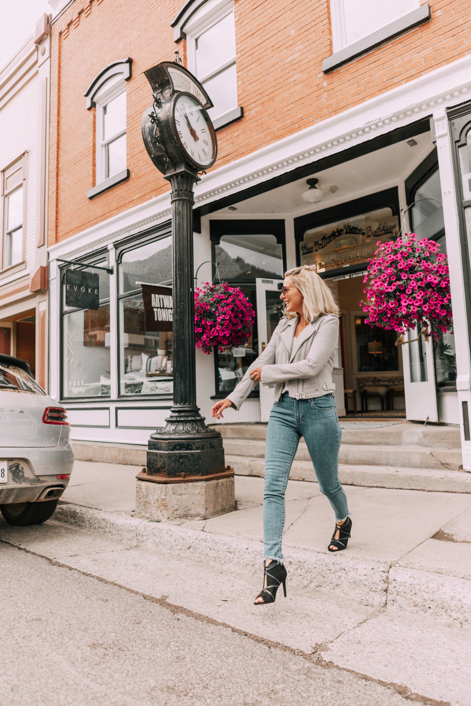 Perfect moto jacket, fashion blogger erin busbee of busbeestyle.com featuring a gray moto jacket with jeans and a white cami in Telluride, Colorado