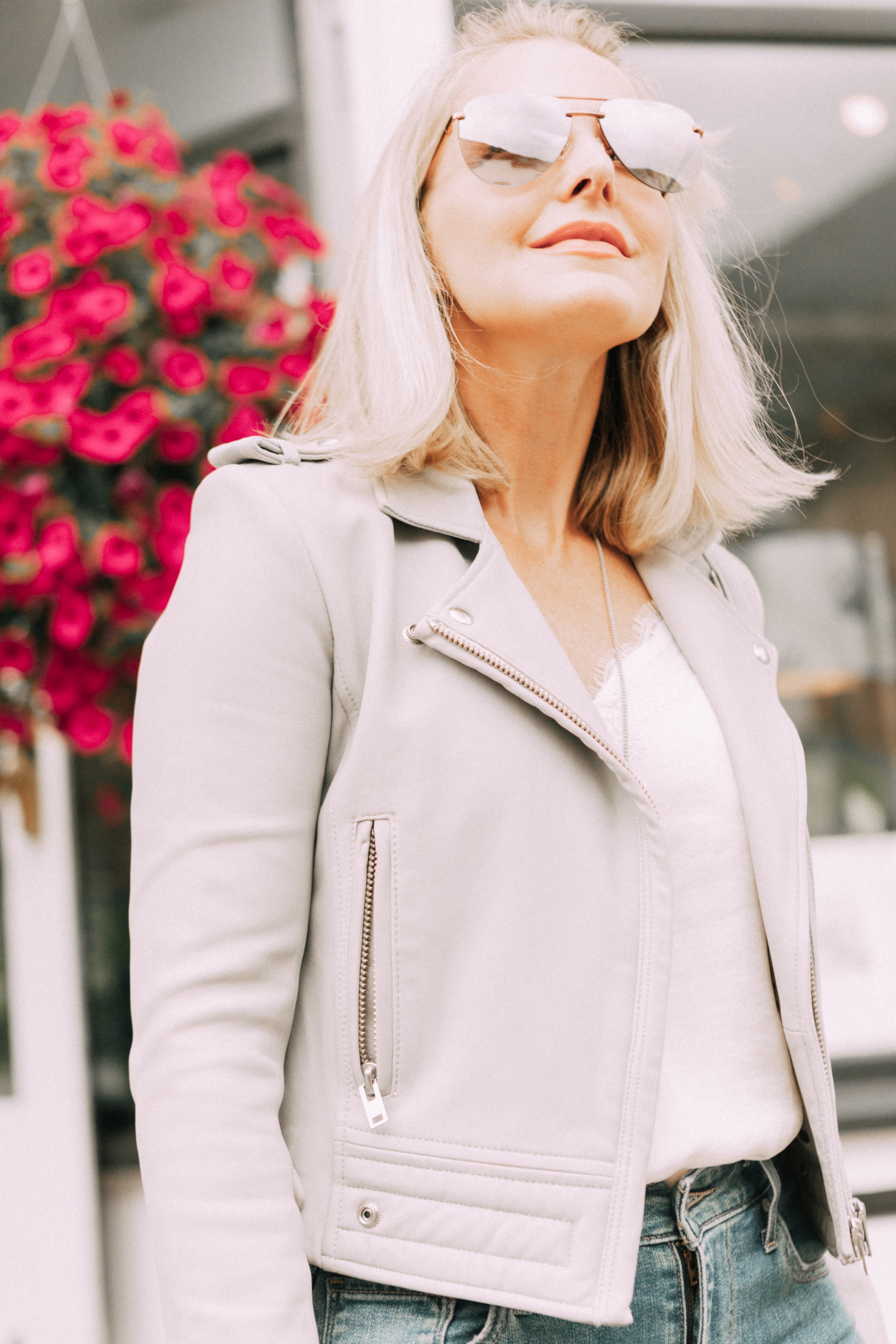 Perfect moto jacket, fashion blogger erin busbee of busbeestyle.com featuring a gray moto jacket with jeans and a white cami in Telluride, Colorado