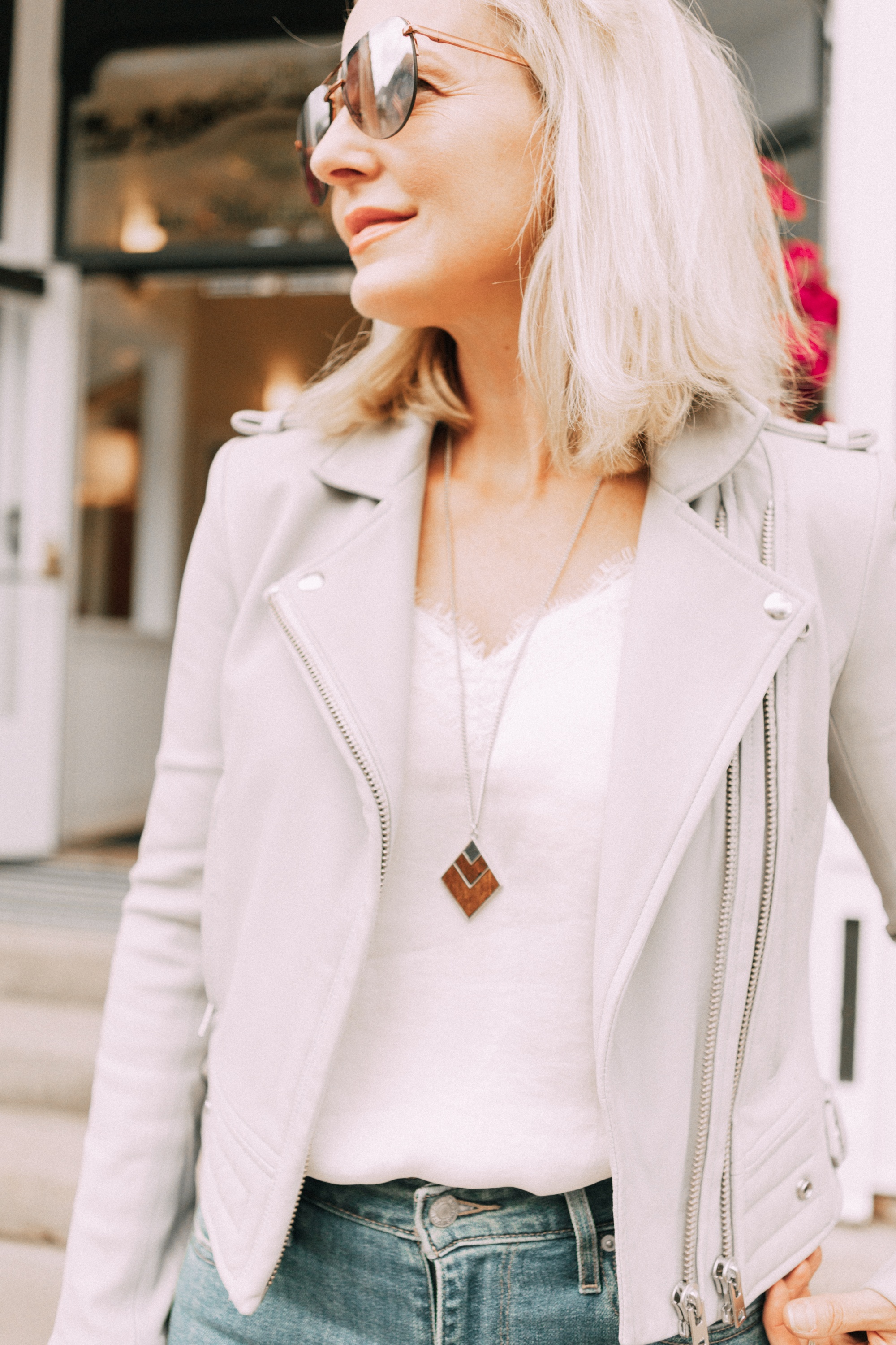 Perfect moto jacket, fashion blogger erin busbee of busbeestyle.com featuring a gray moto jacket with jeans and a white cami in Telluride, Colorado