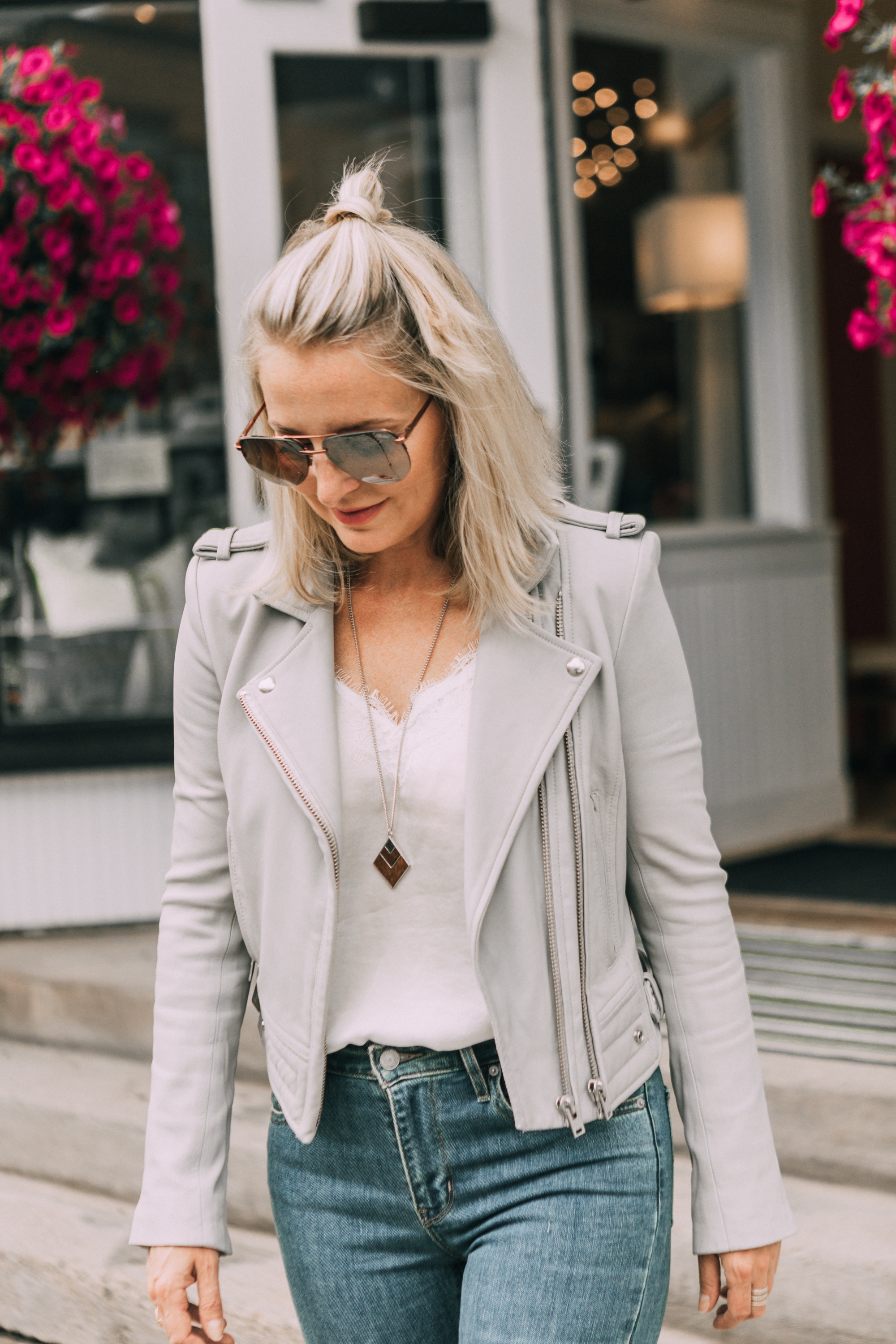 Perfect moto jacket, fashion blogger erin busbee of busbeestyle.com featuring a gray moto jacket with jeans and a white cami in Telluride, Colorado