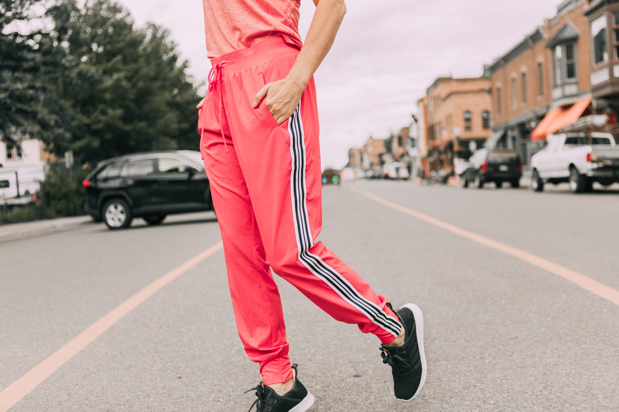 Affordable Activewear From Walmart, Fashion blogger Erin Busbee of BusbeeStyle.com wearing pink racing stripe joggers, pink tank, and pink sports bra by Athletic Works from Walmart in Telluride, CO