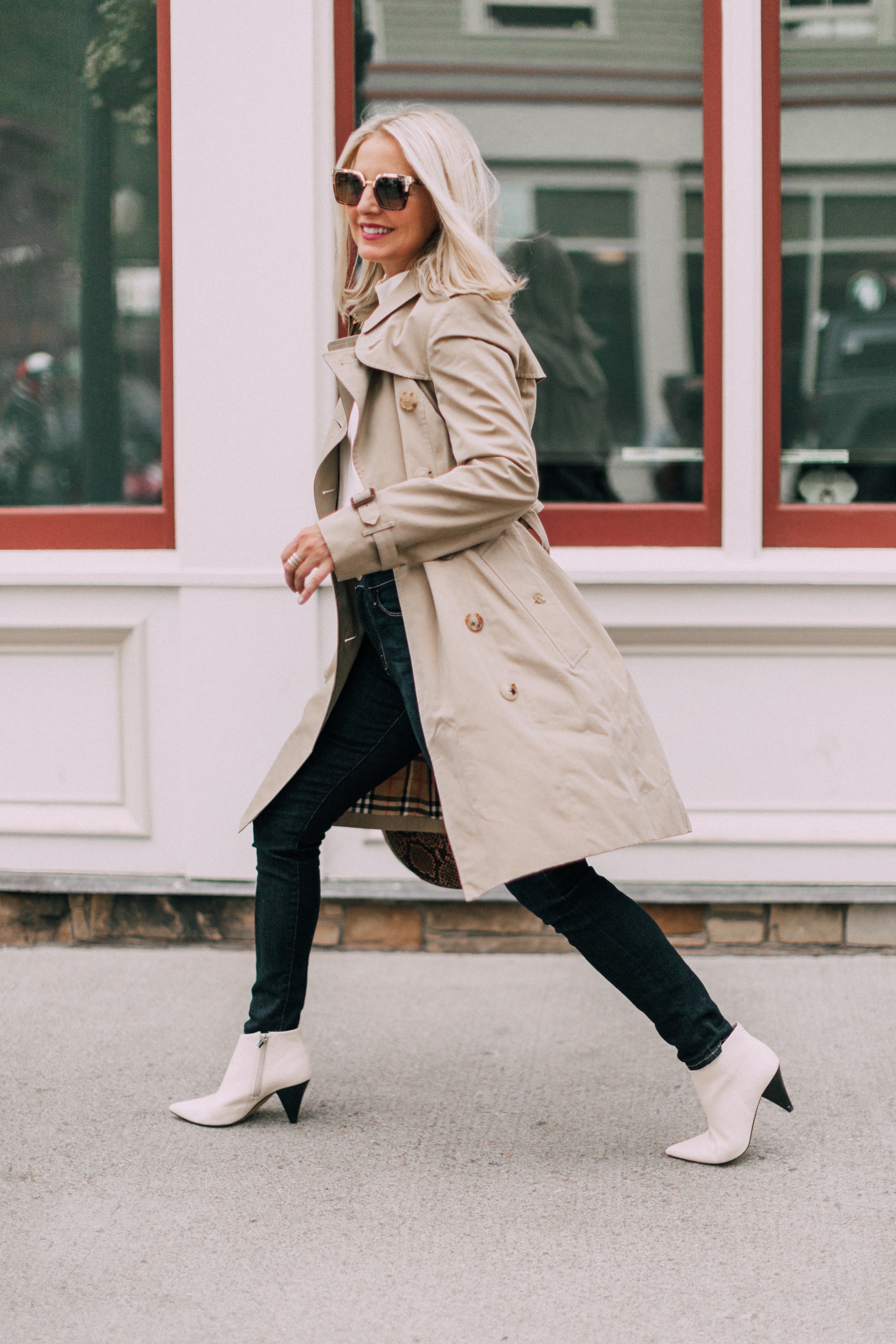 How To Update Your Look, Fashion blogger Erin Busbee of BusbeeStyle.com wearing a white top by Tibi, blue jeans by L'Agence, white cone heel booties by Vince Camuto, python moon bag by Staud, and tan trench coat by Burberry in Telluride, Colorado