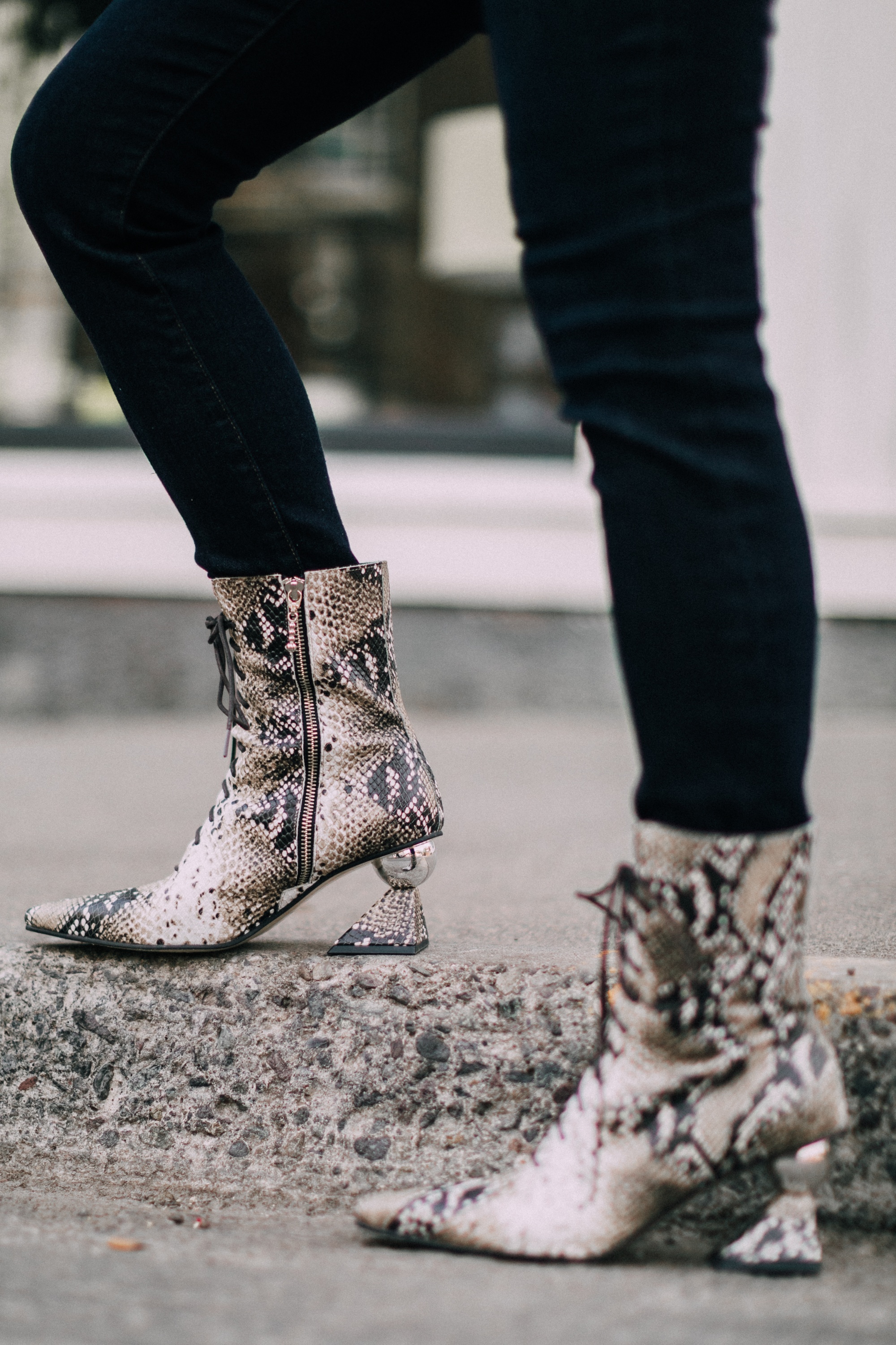 Yuul Yie, Fashion blogger Erin Busbee of BusbeeStyle.com wearing dark wash skinny jeans by L'Agence, leopard print bodysuit by ASTR the label, black Chanel boy bag, and Yuul Yie python boots in Telluride, CO