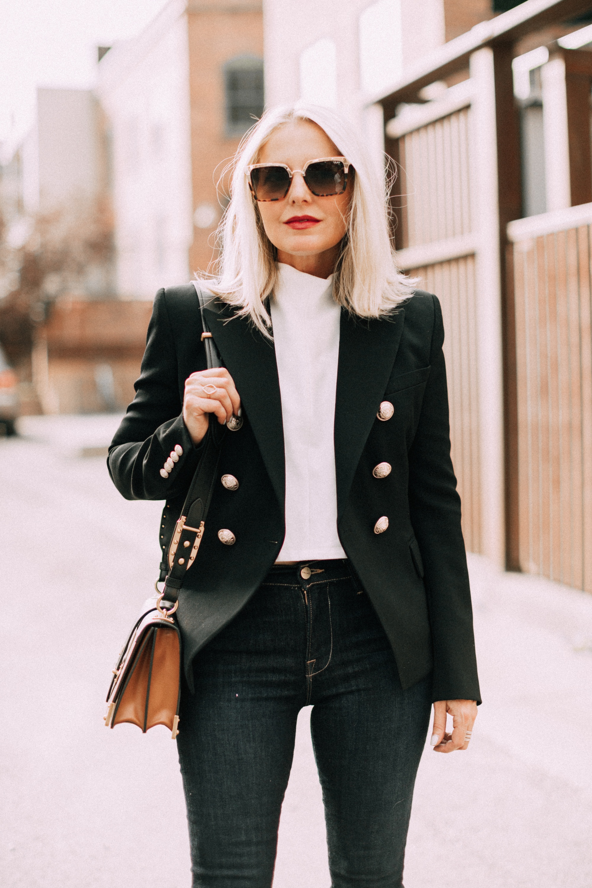 fashion blogger wearing black balmain double breasted wool blazer with dark wash jeans prada cahier crossbody handbag outfit