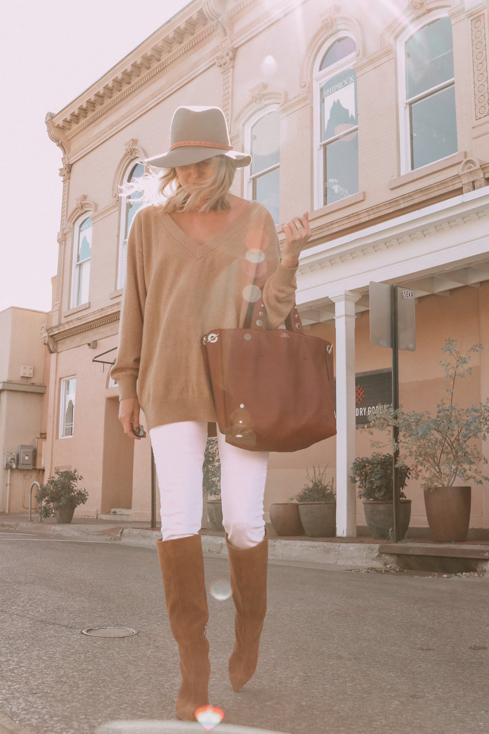 Brown Accessories For Fall, Fashion blogger Erin Busbee of BusbeeStyle.com wearing brown boots and brown tote from Vince Camuto with white jeans, camel sweater, leopard scarf, and Rag & bone hat in Santa Fe, New Mexico